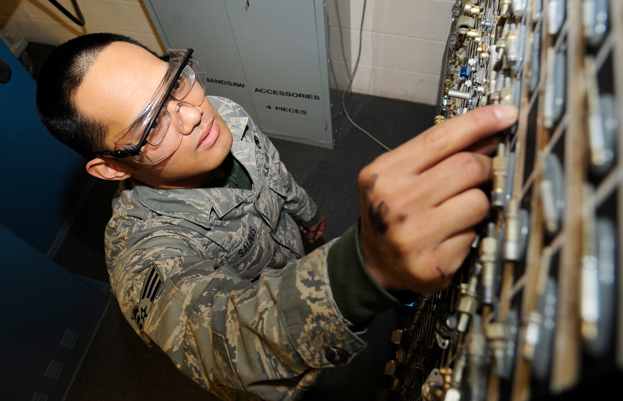 RAF MILDENHALL, England – Senior Airman Vincent Salinas, 100th Maintenance Squadron Aircraft Structural Maintenance journeyman, searches through the “bench stock” library for a replacement nut plate here May 3, 2012. The library is used by aircraft structural maintenance Airmen as a quick reference to hardware parts needed for structural repairs on aircraft. (U.S. Air Force photo/Senior Airman Ethan Morgan)