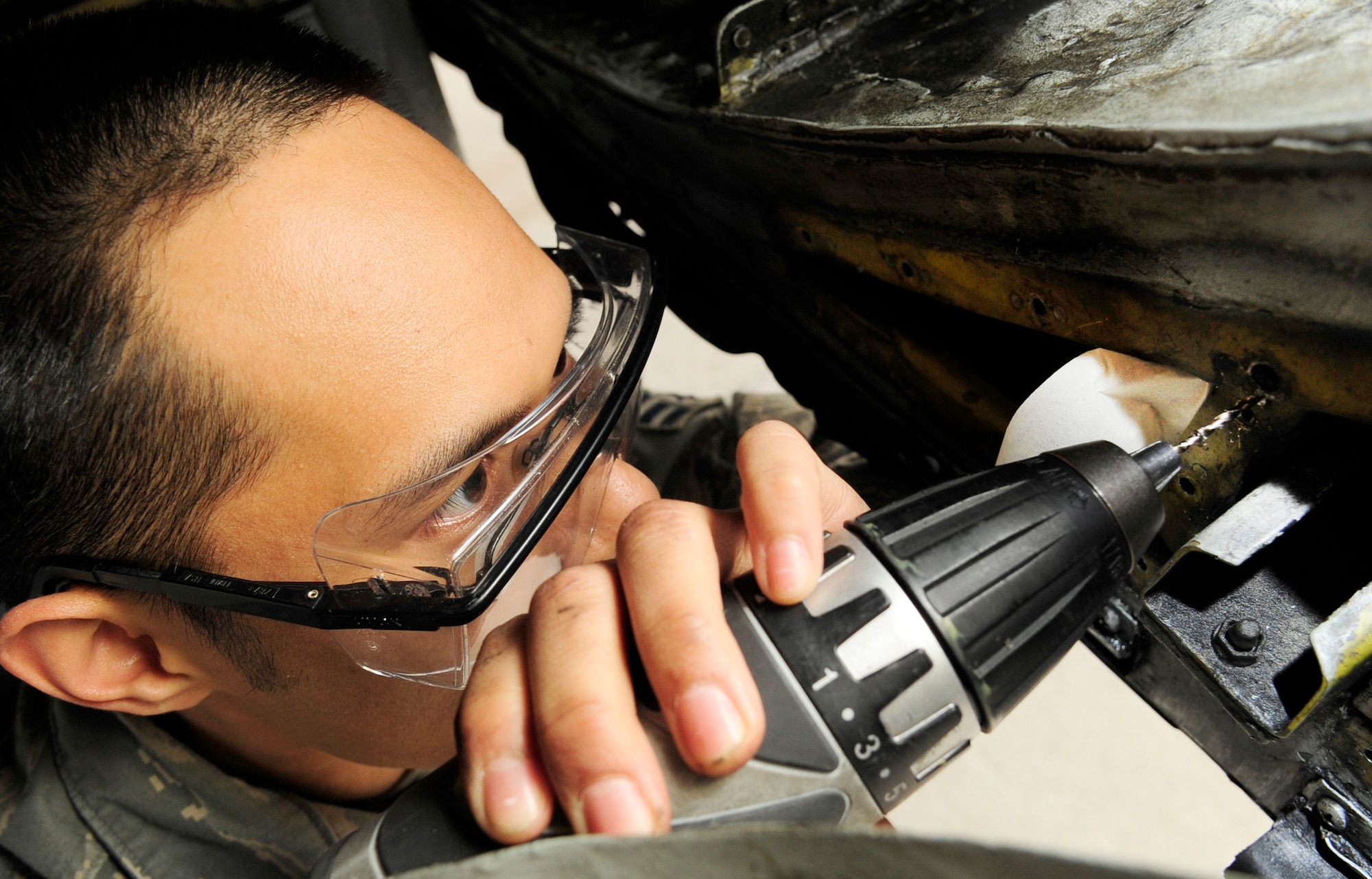 RAF MILDENHALL, England – Senior Airman Vincent Salinas, 100th Maintenance Squadron Aircraft Structural Maintenance journeyman, removes a nut plate on a KC-135 Stratotanker here May 3, 2012.  Nut plates are fasteners that help maintain the structural integrity of the aircraft. (U.S. Air Force photo/Senior Airman Ethan Morgan)