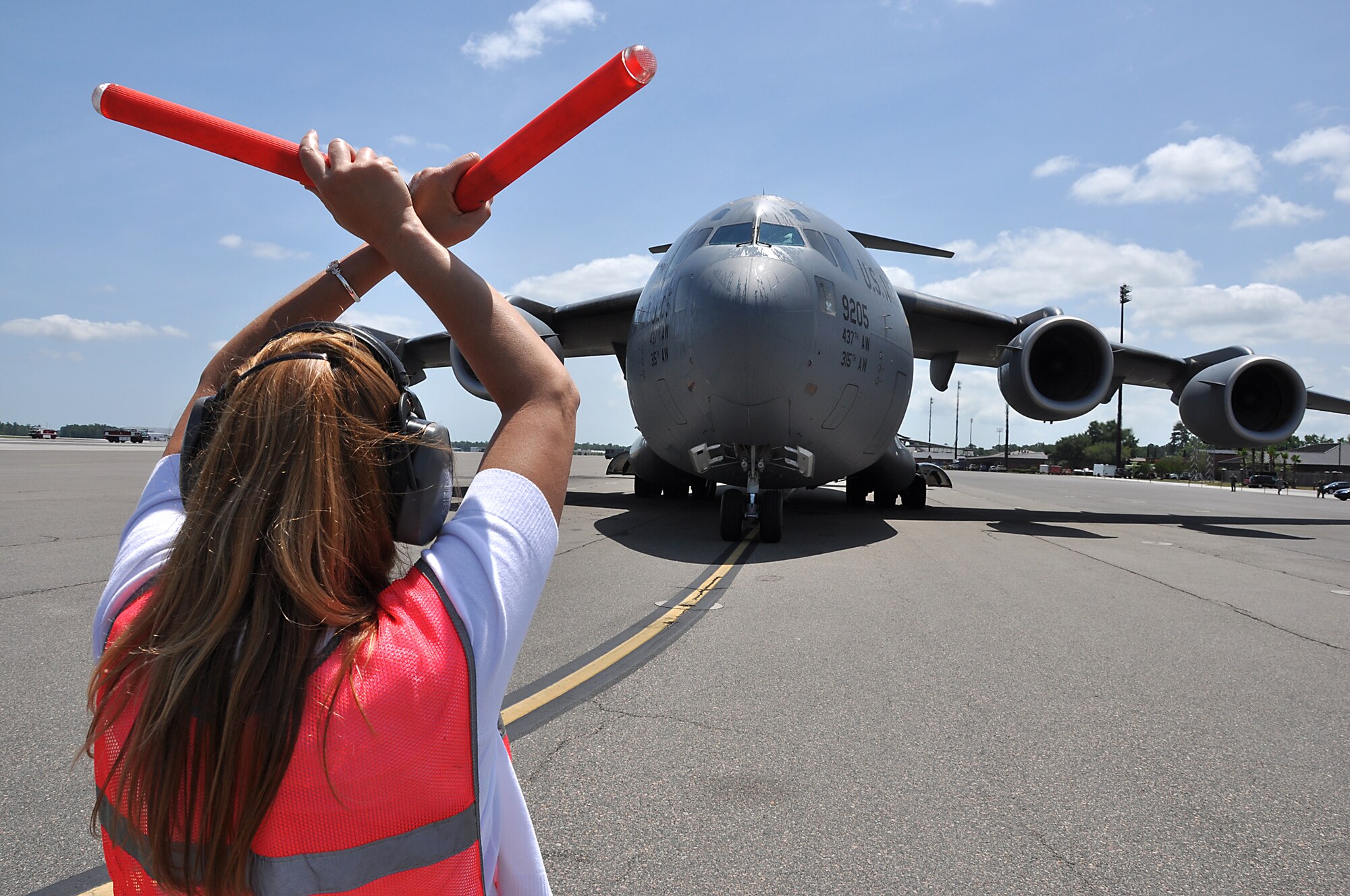Mrs. Janet Chapman marshals her husband plane after Col. Steven Chapman, 315th Airlift Wing commander, landed his "fini flight" in a Charleston C-17 Globemaster III May 3, 2012 at Joint Base Charleston, S.C. (U.S. Air Force photo by Michael Dukes)