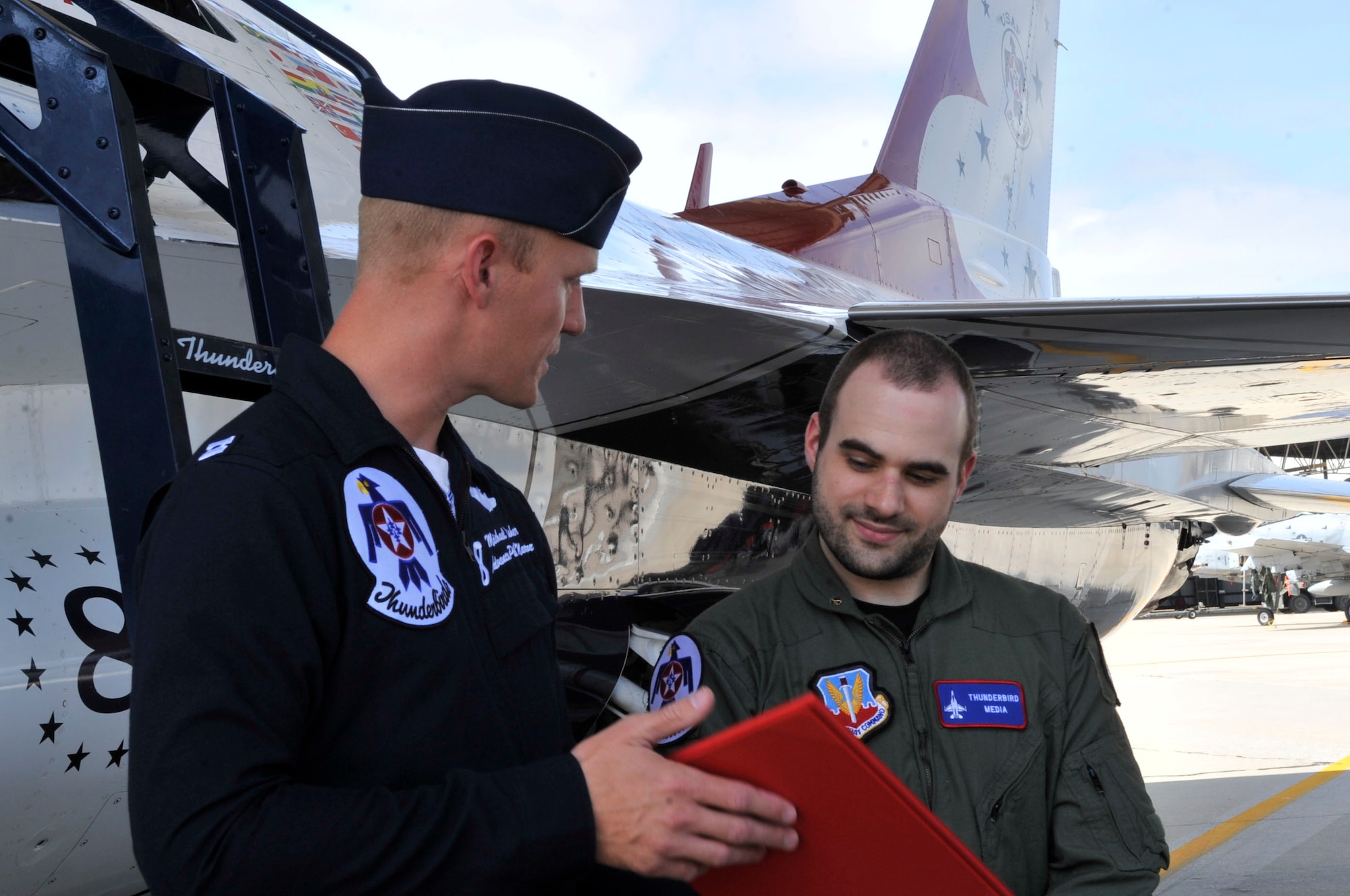 U.S. Air Force Capt. Michael Fisher, U.S. Air Force Air Demonstration Squadron "Thunderbirds" advanced pilot/narrator, presents Nick McCormac, Item reporter, a 9G award at Shaw Air Force Base, S.C., May 3, 2012. Nick attained this award for being able to reach 9G's while in flight.  The Thunderbirds are participating in the Shaw Air Expo May 5 and 6.(U.S. Air Force photo by Airman Nicole Sikorski/Released)