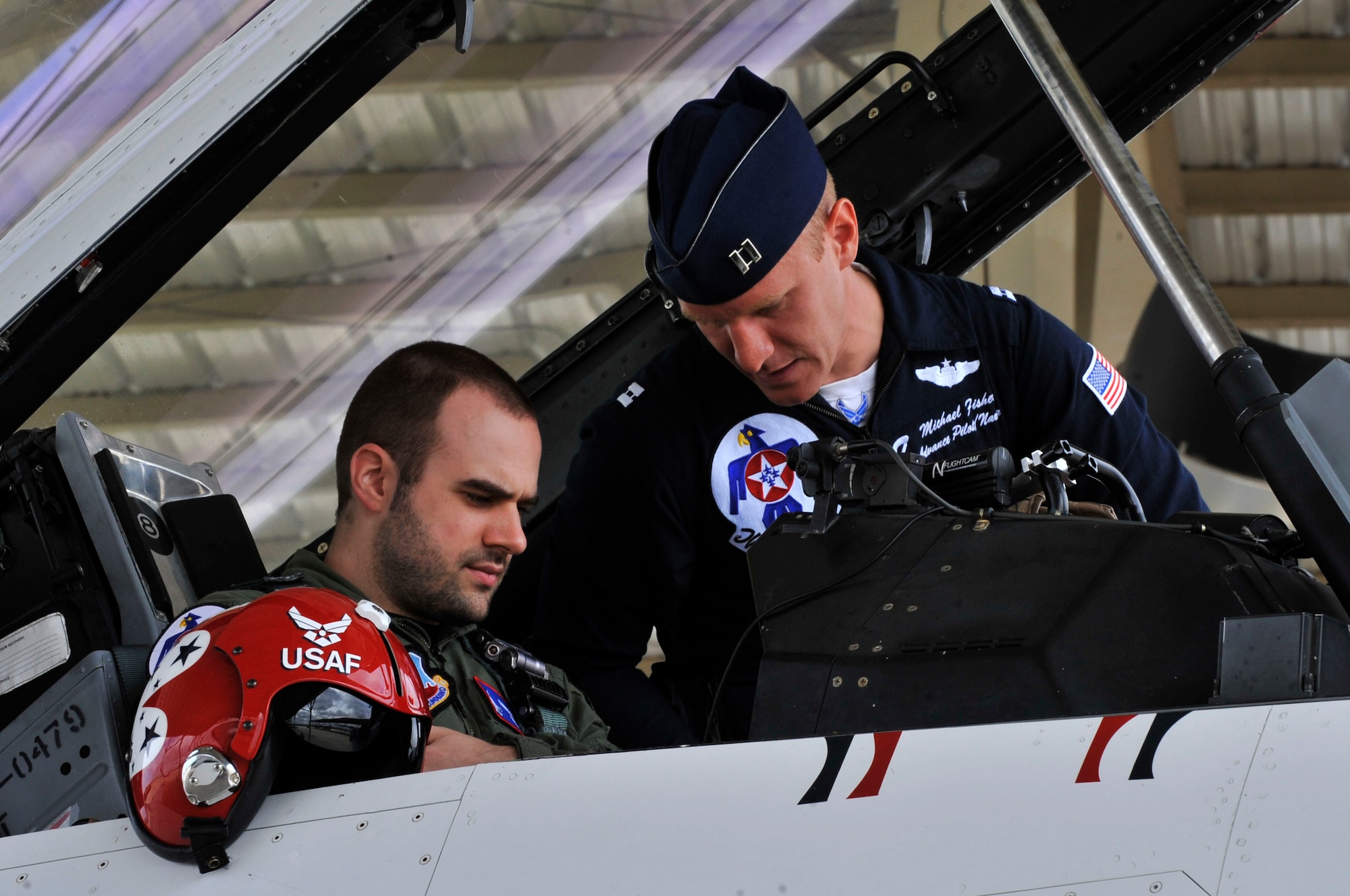 U.S. Air Force Capt. Michael Fisher, U.S. Air Force Air Demonstration Squadron "Thunderbirds" advanced pilot/narrator, prepares for a media flight with Nick McCormac, Item newspaper reporterat Shaw Air Force Base, S.C., May 3, 2012. The Thunderbirds are participating in the Shaw Air Expo May 5 and 6.(U.S. Air Force photo by Airman Nicole Sikorski/Released)