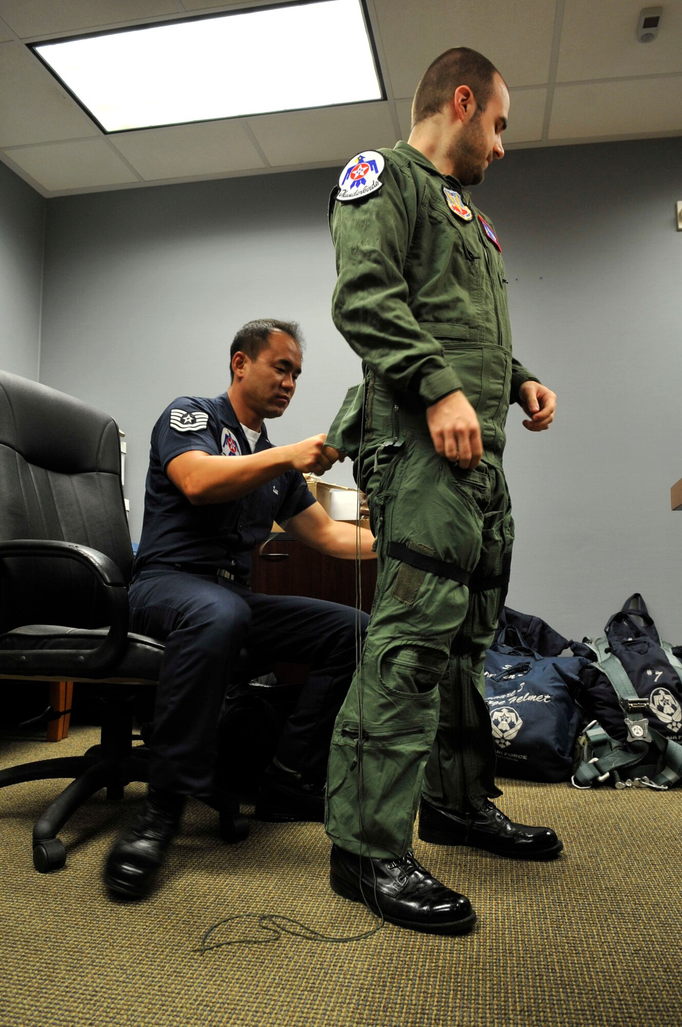 U.S. Air Force Staff Sgt. Sang Lee, U.S. Air Force Air Demonstration Squadron "Thunderbirds" air crew flight equipment specialist, prepares Nick McCormac, Item newspaper reporter, for his Thunderbird media flight at Shaw Air Force Base, S.C., May 3, 2012. The Thunderbirds are  participating in the Shaw Air Expo May 5 and 6.(U.S. Air Force photo by Airman Nicole Sikorski/Released)