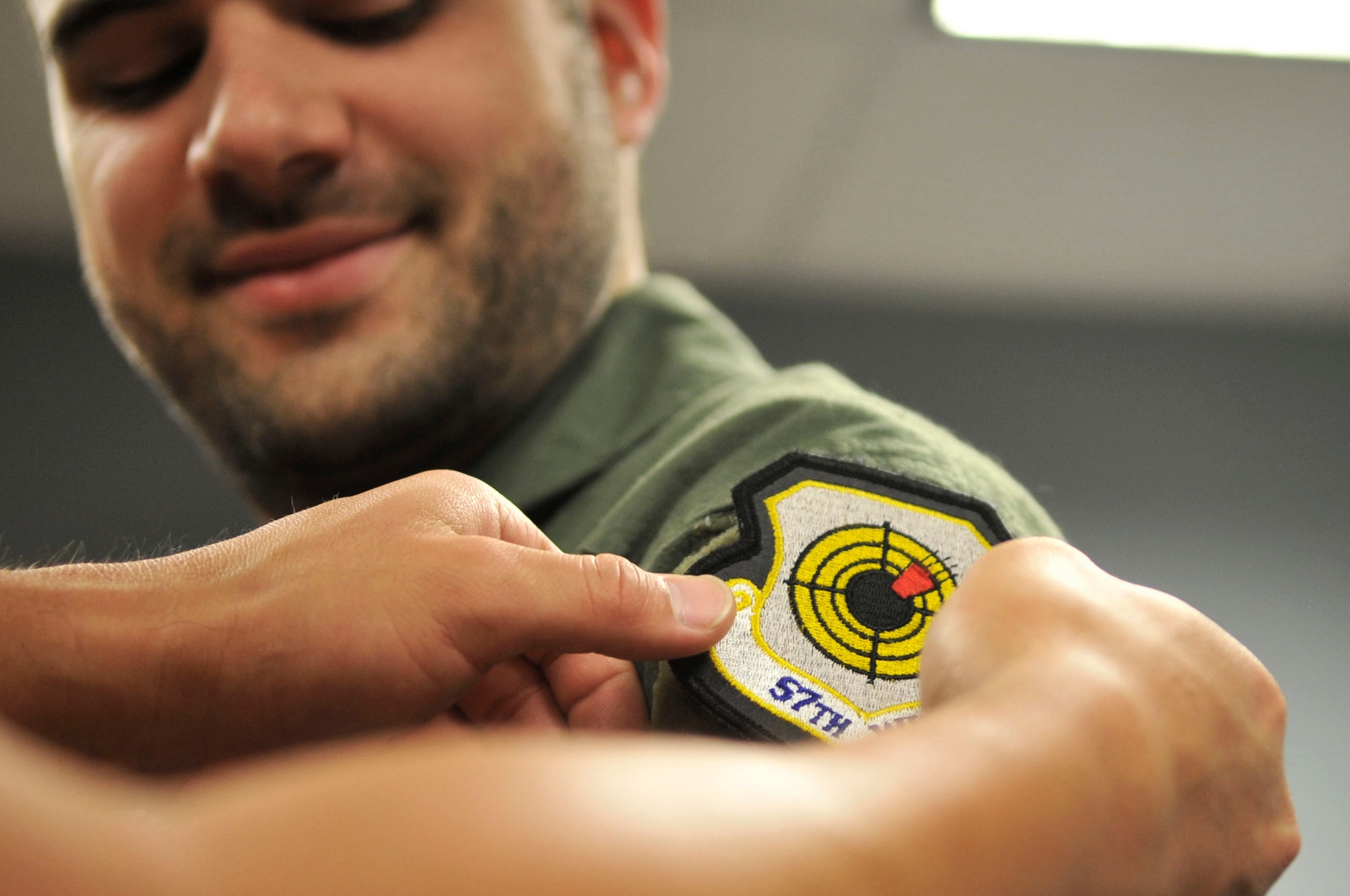 U.S. Air Force Staff Sgt. Sang Lee, U.S. Air Force Air Demonstration Squadron "Thunderbirds" air crew flight equipment specialist, gives a 55th Fighter Squadron patch to Nick McCormac, Item newspaper reporter, at Shaw Air Force Base, S.C., May 3, 2012. McCormac was preparing for his Thunderbird media flight. The Thunderbirds are participating in the Shaw Air Expo May 5 and 6.(U.S. Air Force photo by Airman Nicole Sikorski/Released)