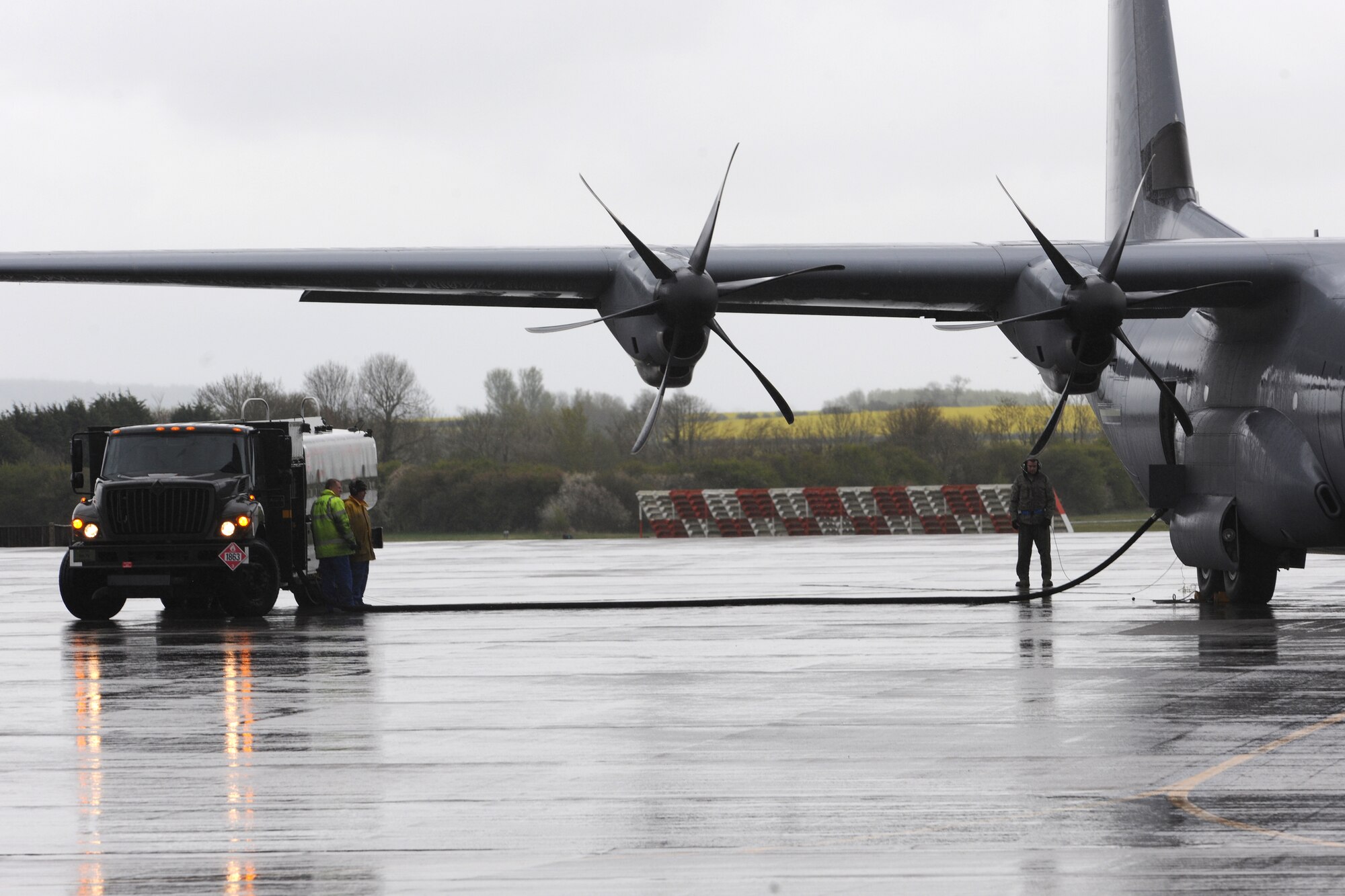 RAF FAIRFORD, United Kingdom - Personnel assigned to the 420th Air Base Squadron assist aircrew from the 86th Airlift Wing to refuel a C-130J during an exercise here April 23. The 420th ABS is able to provide everything a unit needs from contingency dormitories, fitness equipment, fuel for aircraft or vehicles, air traffic control support, security and even meals for a contingency operation or exercise. (U.S. Air Force photo by Senior Airman Joel Mease)