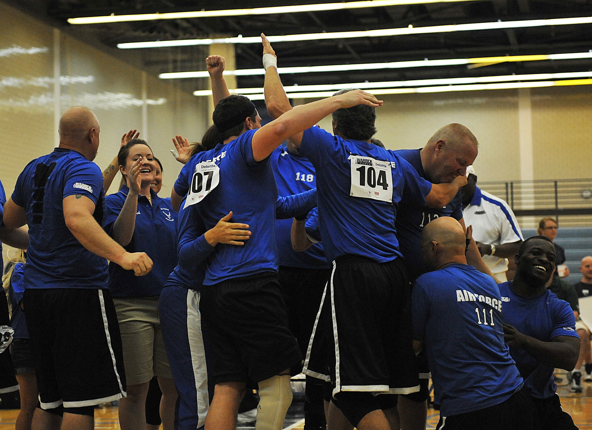 Members of the Air Force sitting volleyball team celebrate after winning the bronze medal against the Special Operations Command team during Warrior Games 2012 at the U.S. Air Force Academy in Colorado Springs, Colo., May 3, 2012. Air Force won 25-12 and 25-20. (U.S. Air Force photo by Val Gempis/Released)