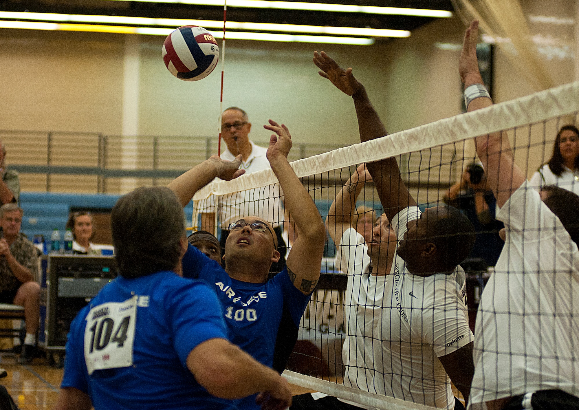 U.S. Air Force Master Sgt. Christopher Aguilera, back center, with the Air Force team, battles for the ball during his team's sitting volleyballl bronze medal game against the Special Operations Command team during Warrior Games 2012 at the U.S. Air Force Academy in Colorado Springs, Colo., May 3, 2012. Air Force won 25-12 and 25-20. (U.S. Air Force photo by Val Gempis/Released)