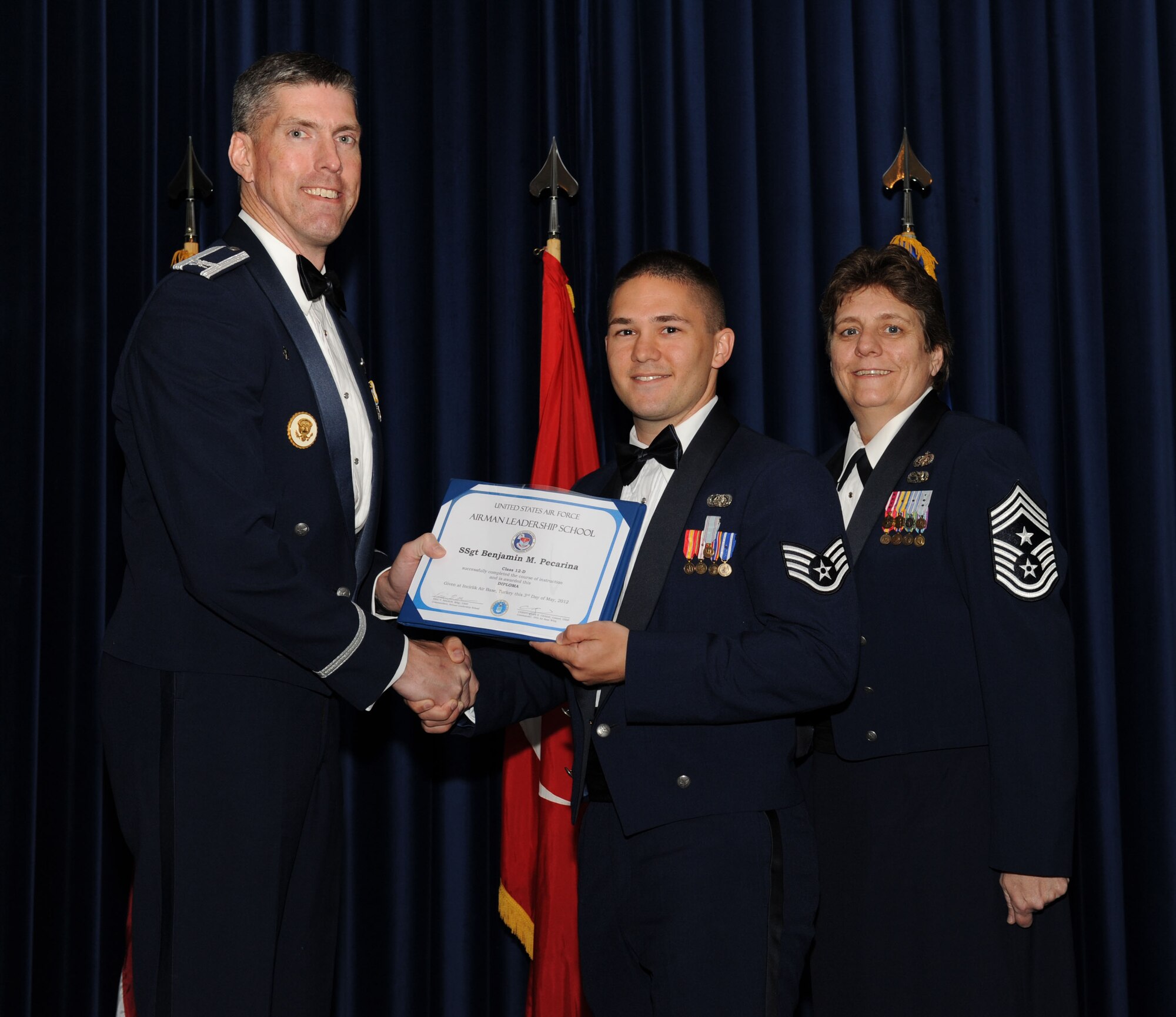 Staff Sgt. Benjamin Pecarina, American Forces Network Incirlik, receives his diploma from Col.Chris Craige, 39th Air Base Wing commander, during the Class 12-D Incirlik Airman Leadership School graduation May 3, 2012, at Incirlik Air Base, Turkey. Pecarina was also awarded the John L. Levitow Award which is the highest achievement for enlisted Airmen enrolled in U.S. Air Force professional military education. There are four levels of PME: ALS, NCO Academy, Air Force Senior NCO Academy and Chief Master Sergeant Leadership Course. (U.S. Air Force photo by Senior Airman Jarvie Z. Wallace/Released)