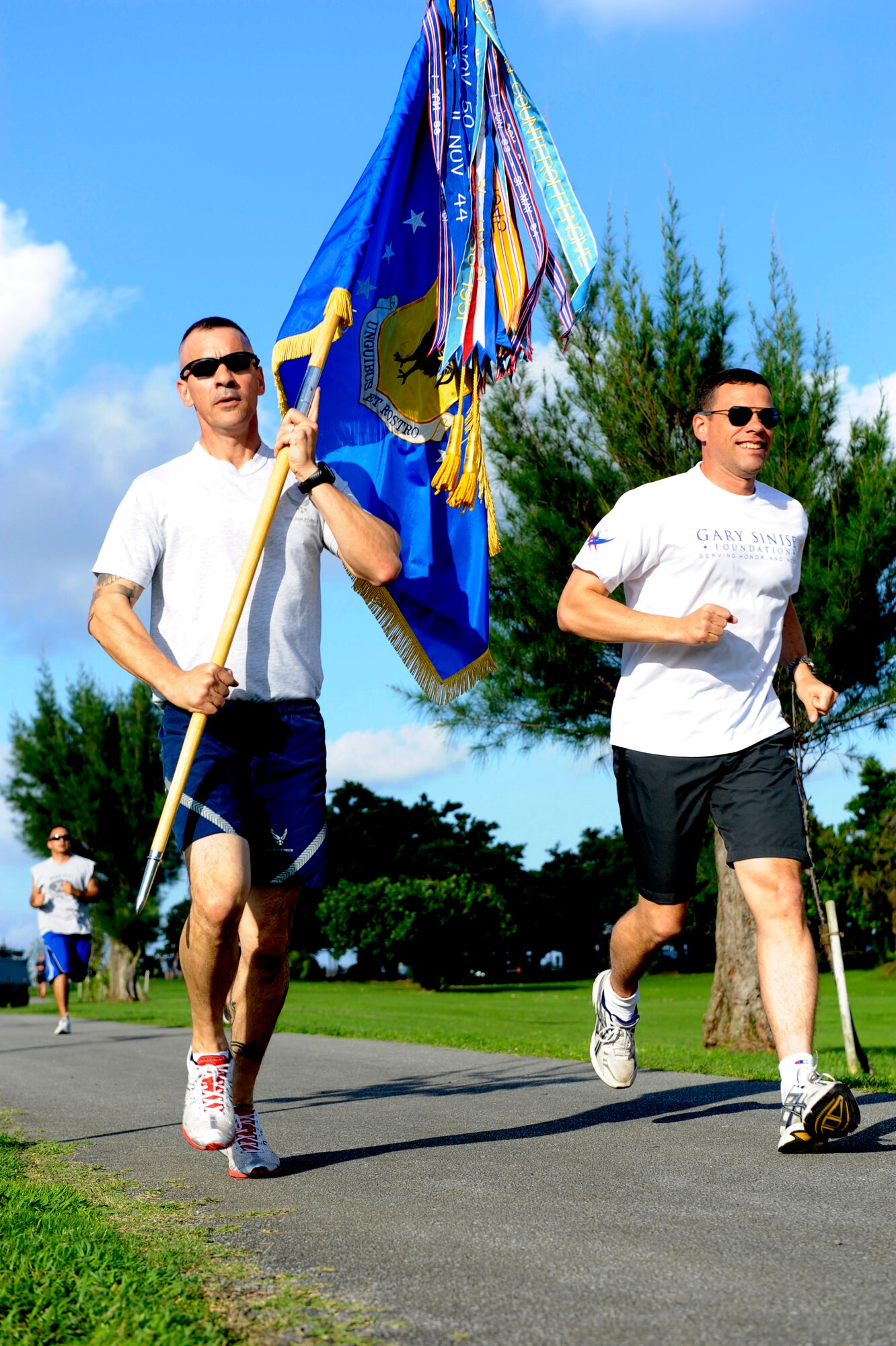 U.S. Air Force Brig. Gen. Matthew Molloy, 18th Wing commander, and Chief Master Sgt. Mark Marson, 18th Wing command chief, sprint during the Building for America's Bravest jog-a-thon on Kadena Air Base, Japan, May 3, 2012. The 24-hour fundraiser sponsored by the Gary Sinise Foundation started May 3 with a goal to raise funds to build 10 smart homes for severely wounded veterans. (U.S. Air Force photo/Airman 1st Class Justin Veazie)