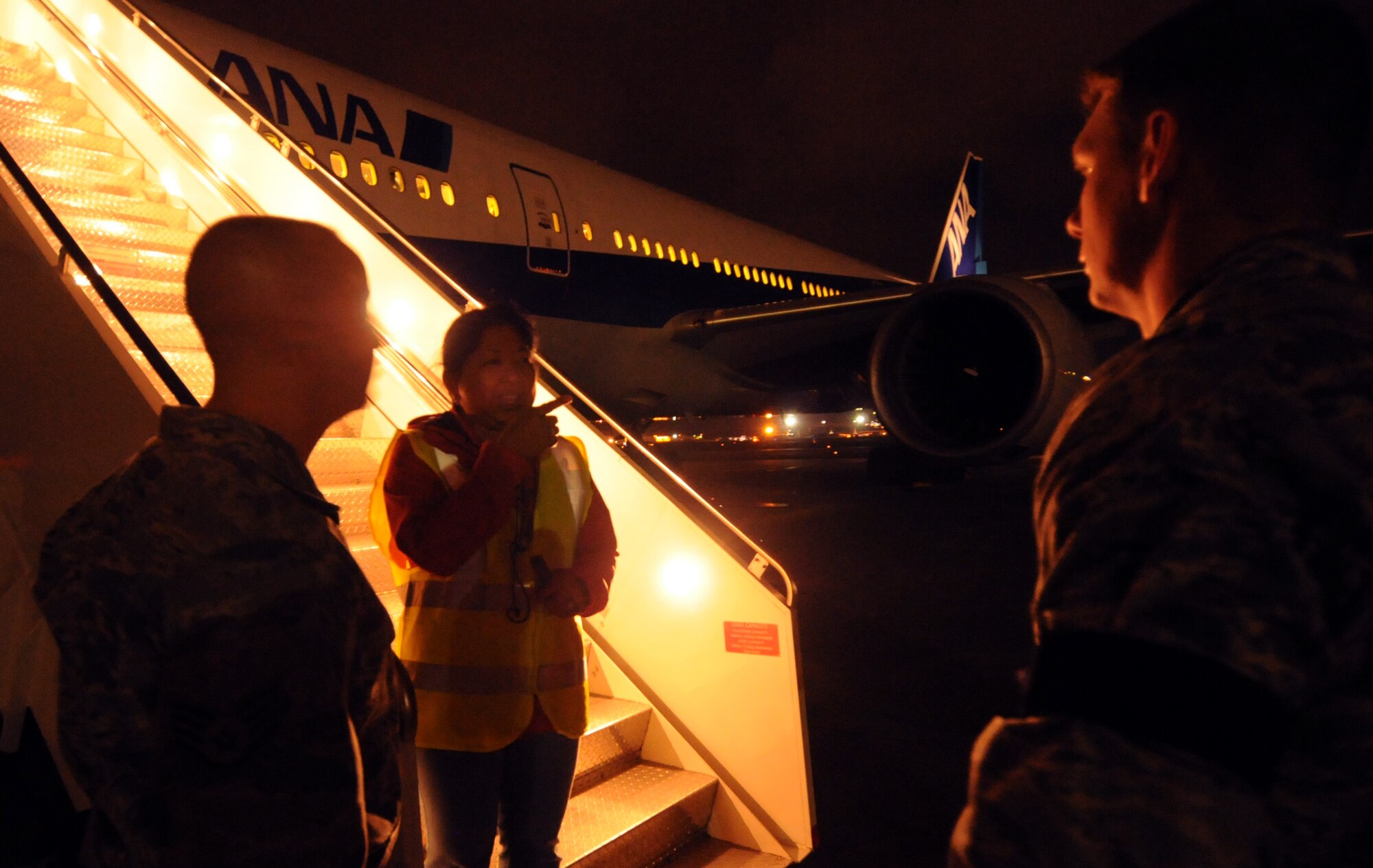 Staff Sgt. Christopher Haibach, 733rd Air Mobility Squadron ramp controller, and Capt. Jack Carroll, 733rd AMS aerial port operations officer, talk with Grace Cadic, a World Airlines representative, about plans to support passengers of a local commercial aircraft diverted from Naha airport to Kadena Air Base, Japan, May 2, 2012. 18th Wing and 733rd AMS personnel assisted by providing air traffic control, ground support, snacks and drinks to crew and passengers as they waited to return to Naha. (U.S. Air Force photo/Tech. Sgt. Jason Lake)