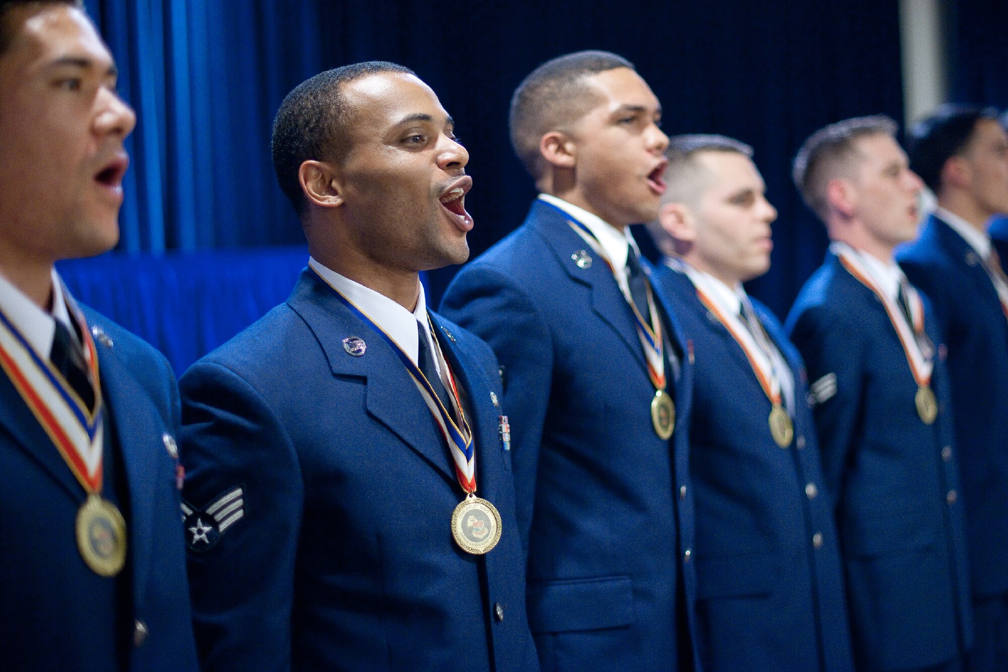 YOKOTA AIR BASE, Japan -- Senior Airman Randall Vaughn (center), 374th Operations Support Squadron, sings the Air Force Song with his fellow classmates from Airman Leadership School Class 12-Delta at the conclusion of their graduation ceremony at Yokota Air Base, Japan, May 3, 2012. (U.S. Air Force photo/Osakabe Yasuo)