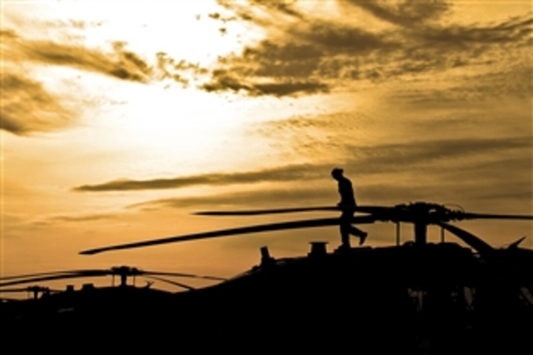 U.S. Army Chief Warrant Officer 2 Norma Garza conducts a pre-flight inspection on a UH-60 Black Hawk helicopter at sunrise on Camp Marmal, Afghanistan, May 2, 2012. Garza is a pilot assigned to the 1st Cavalry Division's Company A, 1st Air Cavalry Brigade, Task Force Lobos.