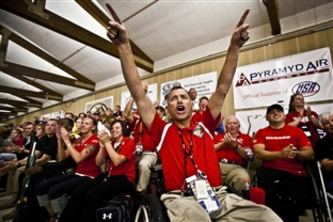 Roger Withrow, a shooting coach for the All-Marine team, cheers for his Marines during the shooting portion of the 2012 Warrior Games at the Olympic Training Center in Colorado Springs, May 3, 2012. The Marines destroyed the competition winning 20 out of 24 medals for the second year in a row.