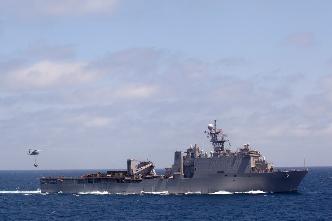 Marines with the 11th Marine Expeditionary Unit and sailors aboard USS Pearl Harbor receive supplies here May 4. The unit is deployed as part of the Makin island Amphibious Ready Group, currently a U.S. Central Command theater reserve force. The group is providing support for maritime operations and theater security cooperation efforts here.