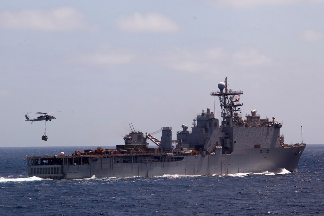 Marines with the 11th Marine Expeditionary Unit and sailors aboard USS Pearl Harbor receive supplies here May 4. The unit is deployed as part of the Makin island Amphibious Ready Group, currently a U.S. Central Command theater reserve force. The group is providing support for maritime operations and theater security cooperation efforts here.