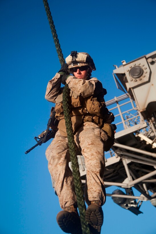 Second Lt. John M. Paul descends 35 feet down a thick, plaited rope rigged to a helicopter parked aboard USS Makin Island here May 4. The 24-year-old San Francisco native serves as a platoon commander with Company I, Battalion Landing Team 3/1. The landing team serves as the ground combat element for the 11th Marine Expeditionary Unit. The unit is deployed as part of the Makin Island Amphibious Ready Group, currently a U.S. Central Command theater reserve force. The group is providing support for maritime security operations and theater security cooperation efforts in the U.S. Navy's 5th Fleet area of responsibility.