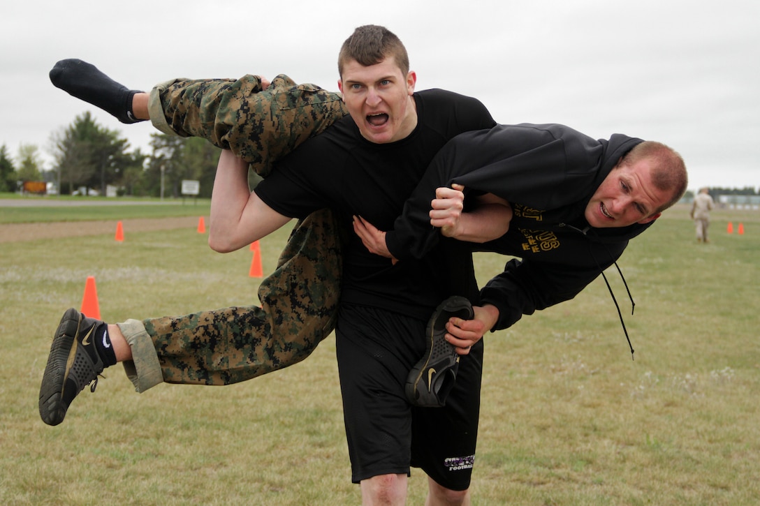 Jeremy Corder, 20, from Chetek, Wis., carries officer candidate Ryan Townsend during the combat fitness test portion of Recruiting Station Twin Cities' mini boot camp May 5. Corder is a member of the Recruiting Substation Eau Claire Delayed Entry Program and ships off to boot camp on Sept. 17. Townsend currently attends Gustavus Adolphus College. For additional imagery from the event, visit www.facebook.com/rstwincities.