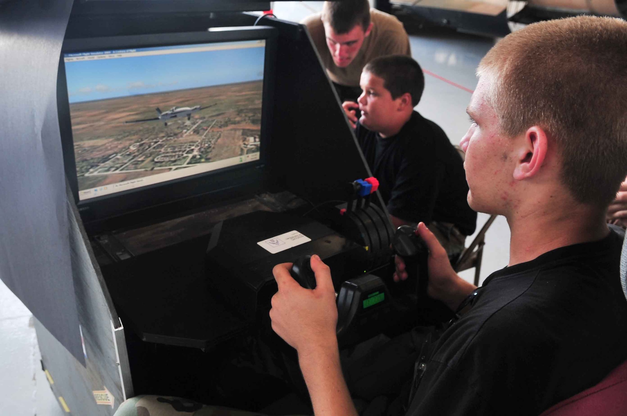 Robert Bass, a member of the Civil Air Patrol, participates in a plane simulator during the 2012 Shaw Air Expo, Shaw Air Force Base, S.C., May 5, 2012. The expo, a biennial event, had events for kids, parents and plane lovers. The event was highlighted by performances from the U.S. Army Golden Knights Parachute team and the U.S. Air Force Demonstration team (Thunderbirds). (U.S. Air Force photo by Airman 1st Class Ashley L. Gardner/ Released)