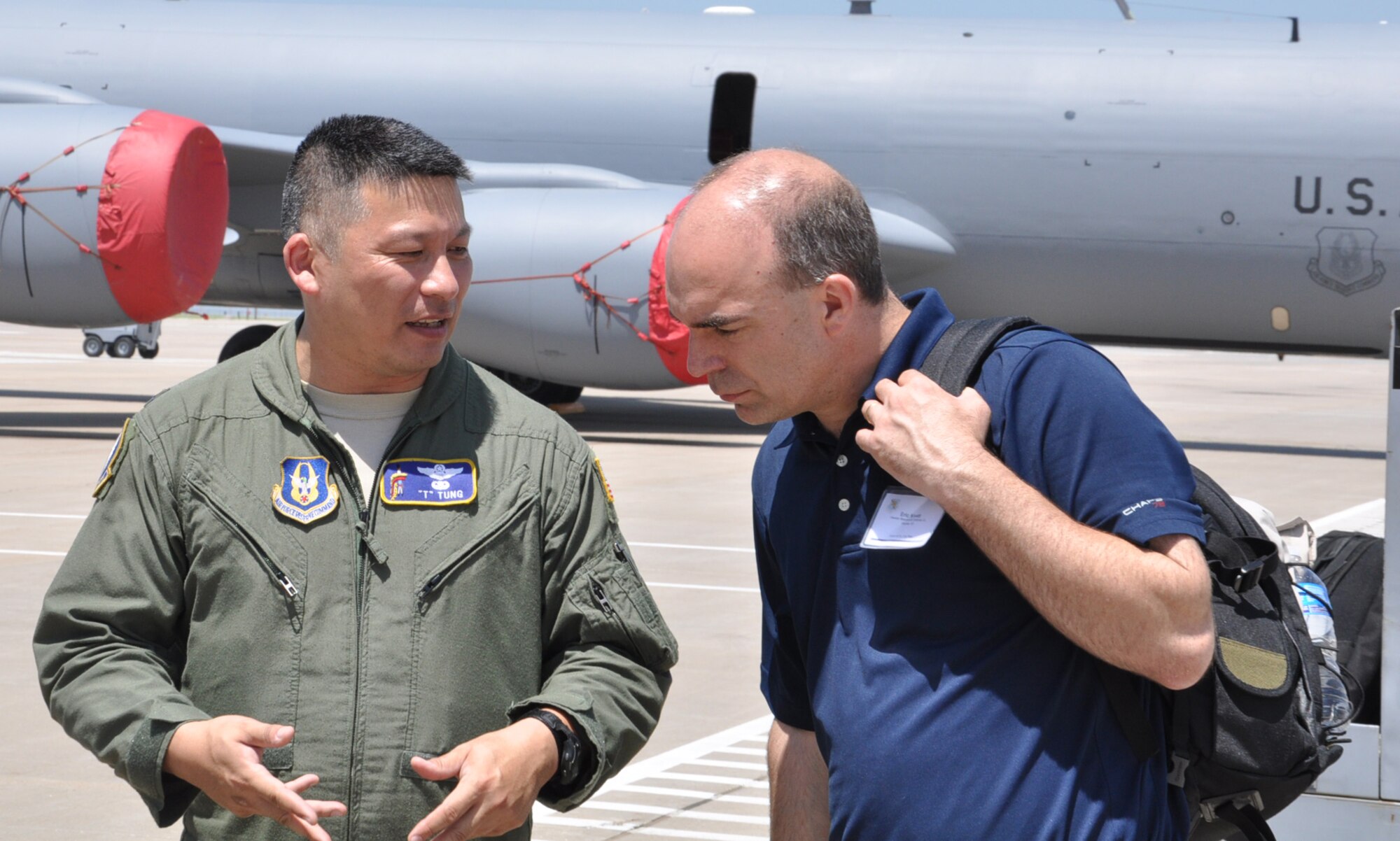 Lt. Col. Tsuyoshi Tung, pilot, 18th ARS, speaks with his civilian supervisor from Hawker Beechcraft, Eric Kivett following the employer orientation flight, May 5. Tung flew the aircraft that transported the employers. (Air Force photo by Tech. Sgt. Brannen Parrish)