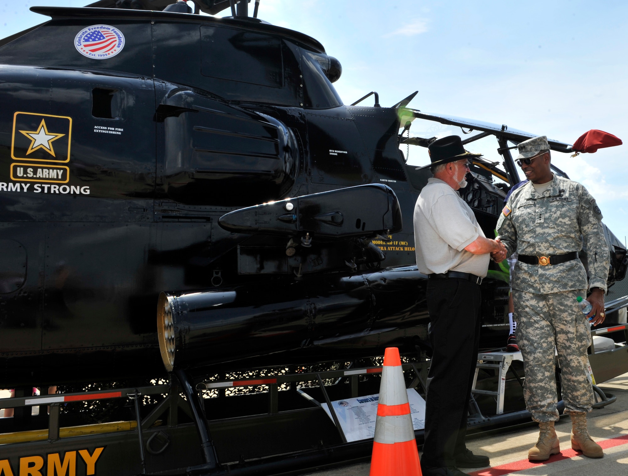 U.S. Army Lt. Gen. Vincent Brooks, Third Army/ARCENT commanding general, shakes Jim Filiatreault's hand and thanks him for coming out to the Shaw Air Expo 2012 at Shaw Air Force Base, S.C., May 5, 2012. Filiatreault showcases the Cobra F model helicopter during parades, large shows, and at high schools. The Cobra helicopter has a 20 mm canon that shoots out 13 rounds of 20 mm bullets per second.(U.S. Air Force photo by Senior Airman Tabatha McCarthy/released)