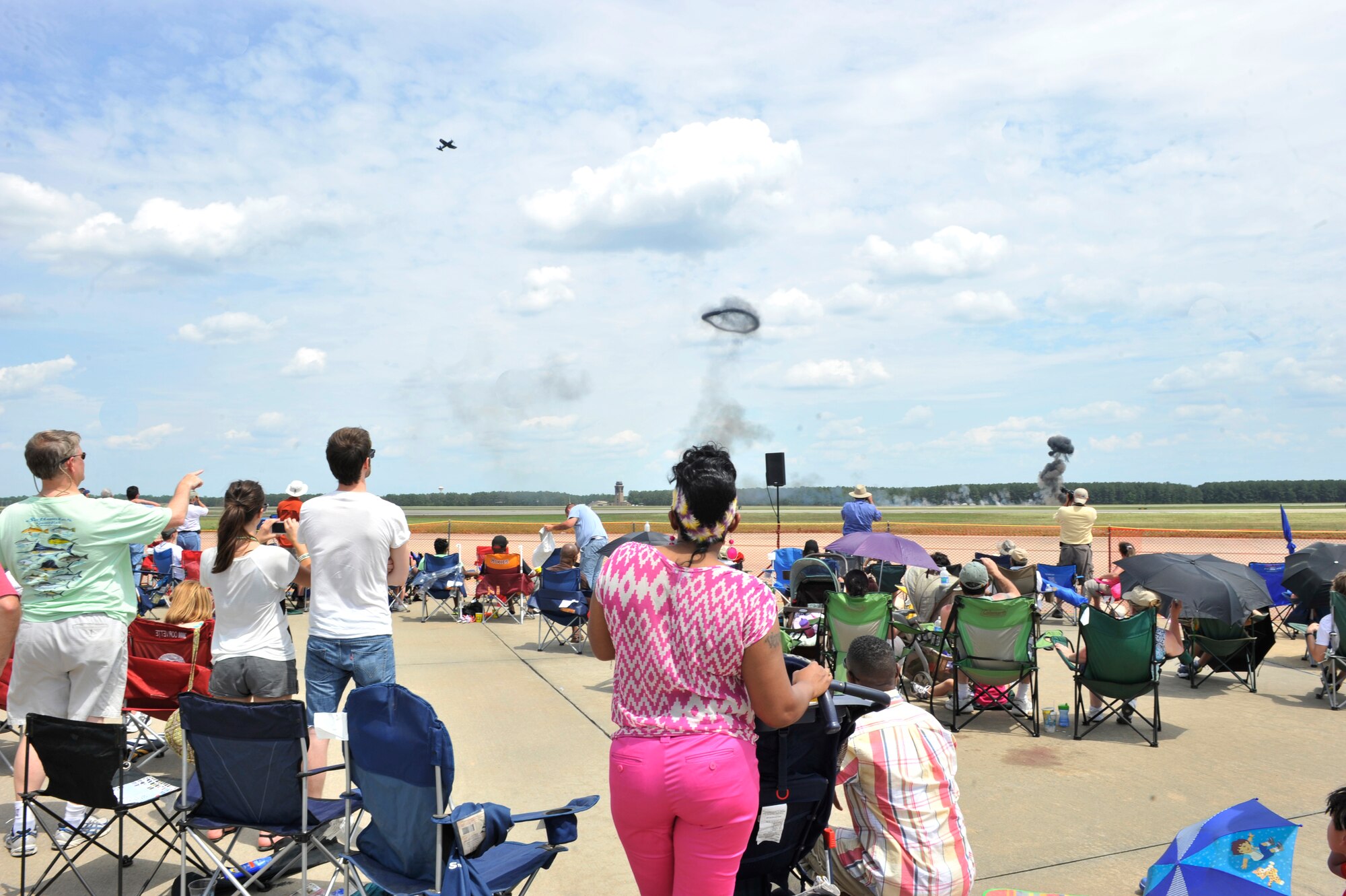Airplane enthusiasts watch the military air power demo during the Shaw Air Expo at Shaw Air Force Base, S.C., May 5, 2012. Shaw Air Expo is held biennually for the public and any military member to view numerous static displays and performers. (U.S. Air Force photo by Senior Airman Tabatha McCarthy/released)