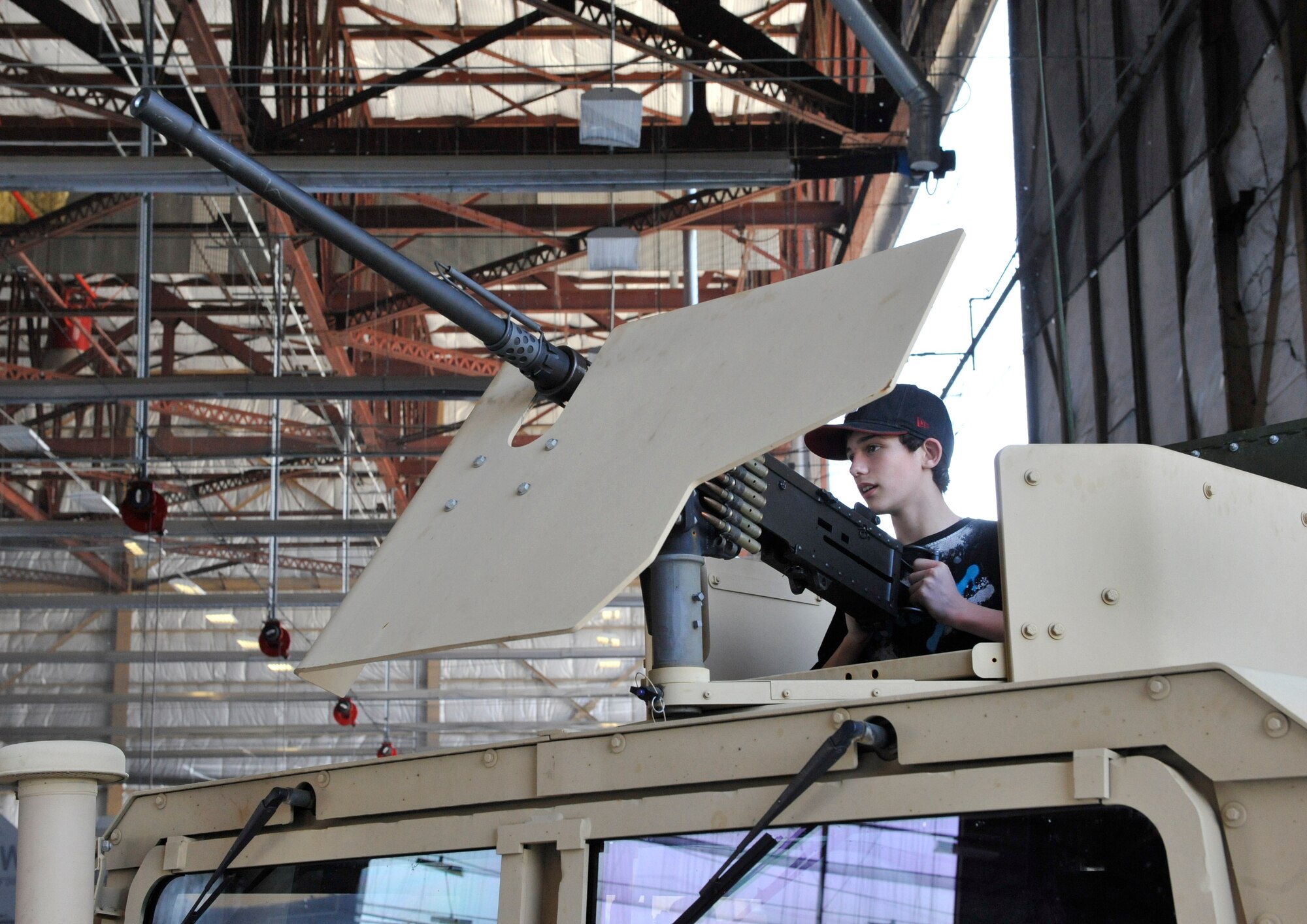 Zachary Ard, from Sumter S.C., checks out a 50 caliber machine gun on top of an armored vehicle during the Shaw Air Expo at Shaw Air Force Base, S.C., May 5, 2012. The Shaw Expo features many different displays and equipment used by the military to include different types of weapons and vehicles currently in use by deployed service members. The Shaw Air Expo will be held both May 5 and 6 will feature more than 28 static displays and 19 performers.  (U.S. Air Force photo by Senior Airman Amber E. N. Jacobs/Released) 