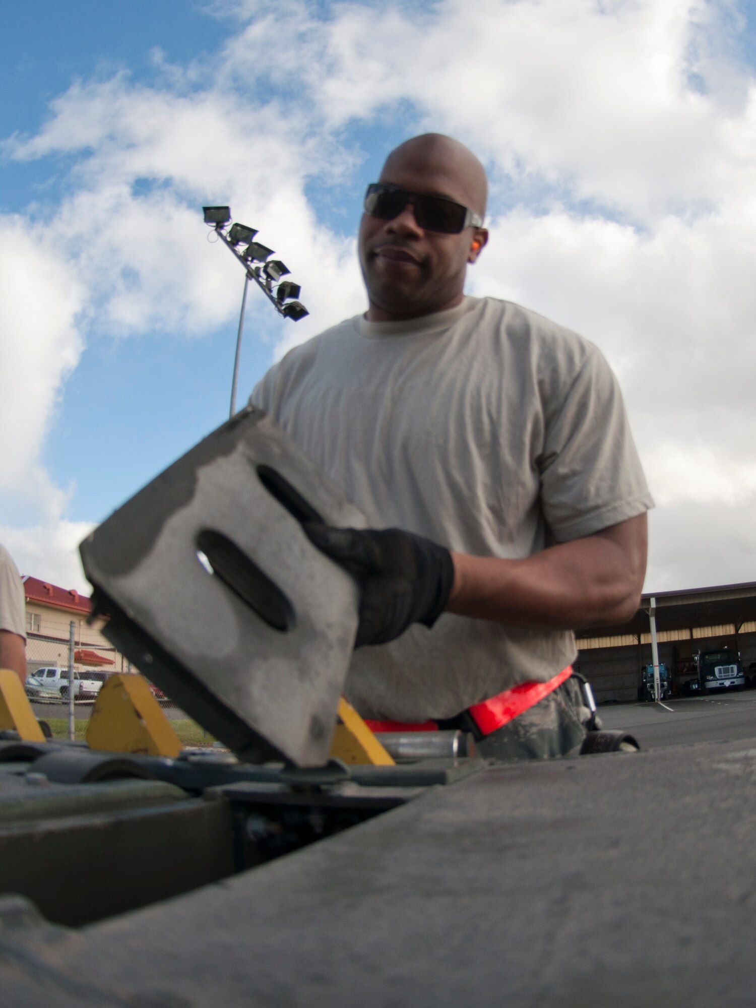 JOINT BASE PEARL HARBOR-HICKAM, Hawaii- Master Sgt. Danny Thomas, 48th Aerial Port Squadron air transportation specialist, flips over a roller plate in preparation for reconfiguring a cargo loader during the hands-on portion of training. Members of the 48th APS recently completed training on a cargo loader here. Training included classroom work and a load mission on an aircraft. The loader is used to load and unload cargo aircraft and the aerial porters must mainitain their qualifications with a annual refresher course.  (U.S. Air Force photo/Staff Sgt. Kyle Brasier)
