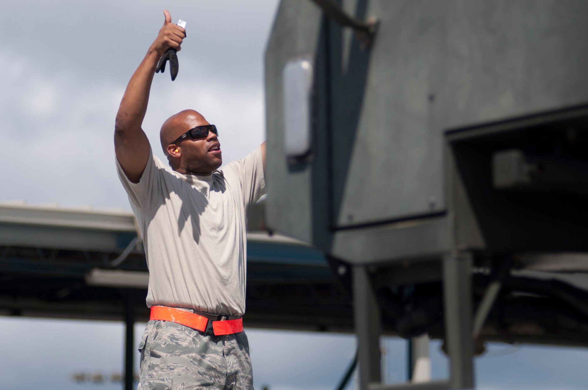 JOINT BASE PEARL HARBOR-HICKAM, Hawaii- Master Sgt. Danny Thomas, 48th Aerial Port Squadron air transportation specialist, marshals a cargo loader. Members of the 48th APS recently completed training on a cargo loader here. Training included classroom work and a load mission on an aircraft. The loader is used to load and unload cargo aircraft and the aerial porters must mainitain their qualifications with a annual refresher course.  (U.S. Air Force photo/Staff Sgt. Kyle Brasier)