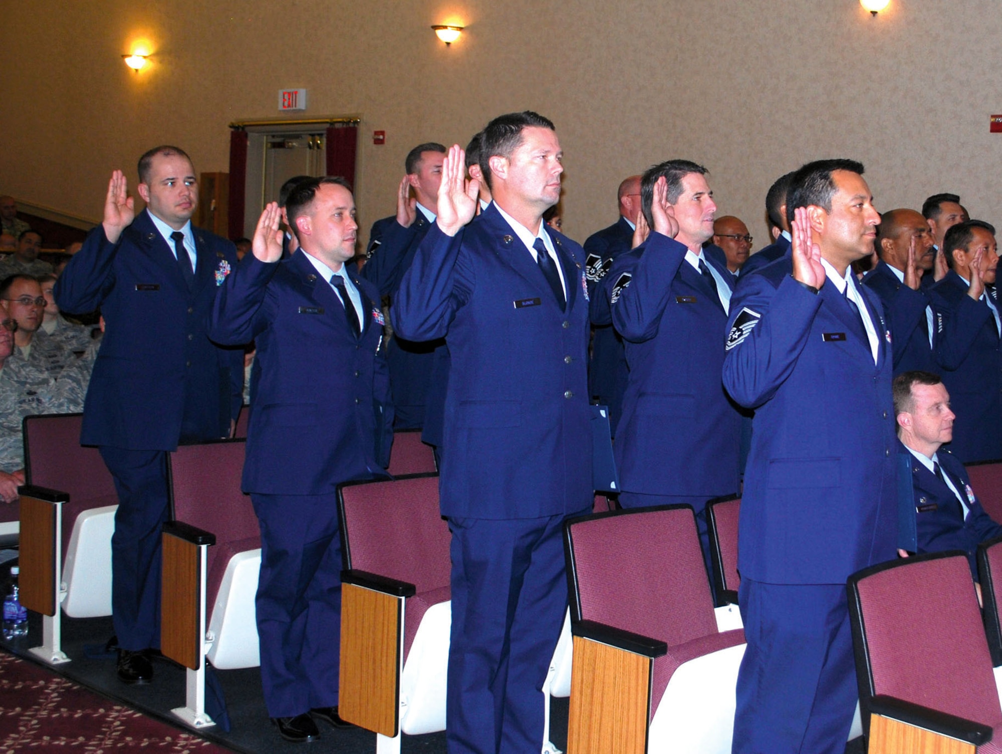 Inductees stand with right hands risen to accept charges as Senior Non-Commissioned Officers. March Field held its Senior NCO and NCO induction ceremony, April 22, at the Cultural Resource Center. (Inductees in attendace listed in alphabetical order, Master Sgts. Angel Adame, Stoddard E.W. Black, Matthew Blonde, Matthew Brough, John Brown, Harvey Clark, Christina Cruz, Arthur Delosantos, Lucila Dickinson, Tracey Ehlin, Steven Gallo, Darlene Gibson, Marcus Gilley, Michelle A. Goodman, John Hershey, Corinius Hill, Derek Holm, Kevin Hunter, Riley D.Krug, Ismael Mota, Javier Murillo, Cesar Oceguera, Ervin Puzon, Juan Rodriguez, Jorge Rodriguez, Gilberto
Romero, Darryl Sanders, Ericht Schoenfeld, Joseph Simpson, Brian Sinclair, Delicia Speller, Jerome Stan, Ronulfo Tabigo-On, Faviola Venegas, Rudy Villavicencio and Richard Williams)  (U.S. Air Force photo)