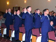 Inductees stand with right hands risen to accept charges as Senior Non-Commissioned Officers. March Field held its Senior NCO and NCO induction ceremony, April 22, at the Cultural Resource Center. (Inductees in attendace listed in alphabetical order, Master Sgts. Angel Adame, Stoddard E.W. Black, Matthew Blonde, Matthew Brough, John Brown, Harvey Clark, Christina Cruz, Arthur Delosantos, Lucila Dickinson, Tracey Ehlin, Steven Gallo, Darlene Gibson, Marcus Gilley, Michelle A. Goodman, John Hershey, Corinius Hill, Derek Holm, Kevin Hunter, Riley D.Krug, Ismael Mota, Javier Murillo, Cesar Oceguera, Ervin Puzon, Juan Rodriguez, Jorge Rodriguez, Gilberto
Romero, Darryl Sanders, Ericht Schoenfeld, Joseph Simpson, Brian Sinclair, Delicia Speller, Jerome Stan, Ronulfo Tabigo-On, Faviola Venegas, Rudy Villavicencio and Richard Williams)  (U.S. Air Force photo)