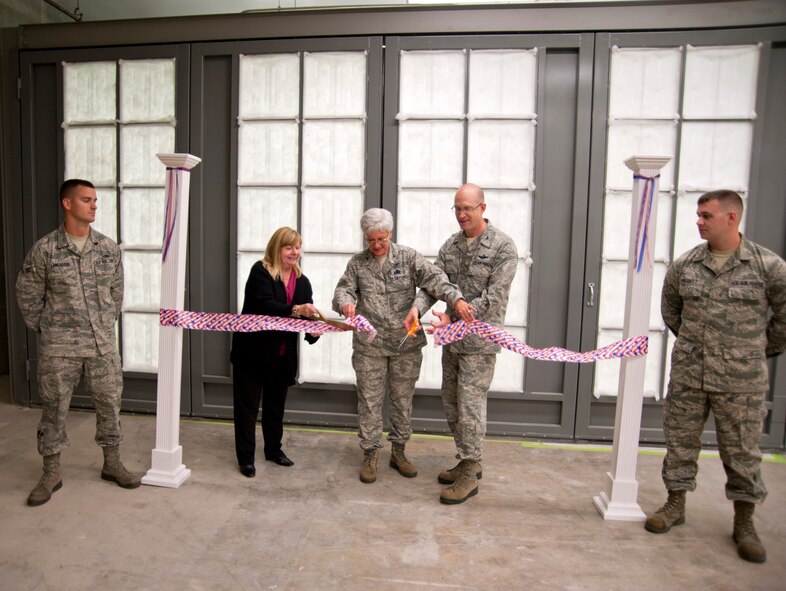 Col. Jay Jensen, Col. Anna Schulte and Hermis Plash cut the ceremonial ribbon to open the Wing's new paint booth. The commanders, Wing and Maintenance Group respectively, congratulated Plash on the fruition of her efforts, which began in 2000, to obtain funding and equipment for a new paint booth. The original paint booth was 27 years old and failed to meet requirements. In September 2010, the equipment was deemed non-operational and forced the Wing's structural shop to go on temporary duty to Duke Field in order to accomplish the required painting of landing gear rims, break housings, and nose landing gear tow fitting assemblies. The new paint booth not only eliminates the need to travel to Duke Field, it allows the Wing to meet corrosion contral requirements for over 200 pieces of aircraft support equipment.