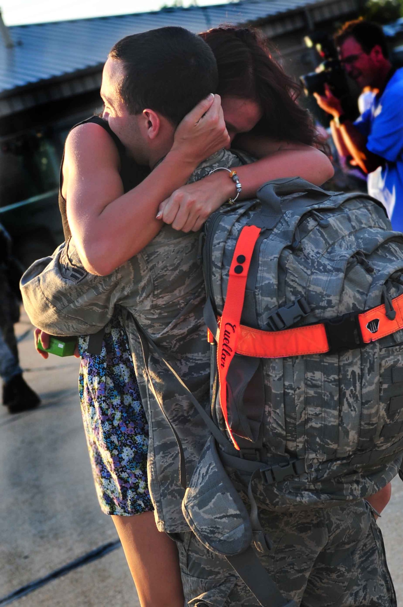 U.S. Air Force Airman 1st Class Thomas Cuellar,  55th Maintenance Squadron crew chief, hugs his girlfriend Briana Holbrick after his return home to Shaw Air Force Base, S.C., May 4, 2012 after completing a four-month deployment. An Airbus A330 aircraft returned with 235 members of the 55th Expeditionary Fighter Squadron. (U.S. Air Force photo by Airman 1st Class Ashley L. Gardner/ Released)