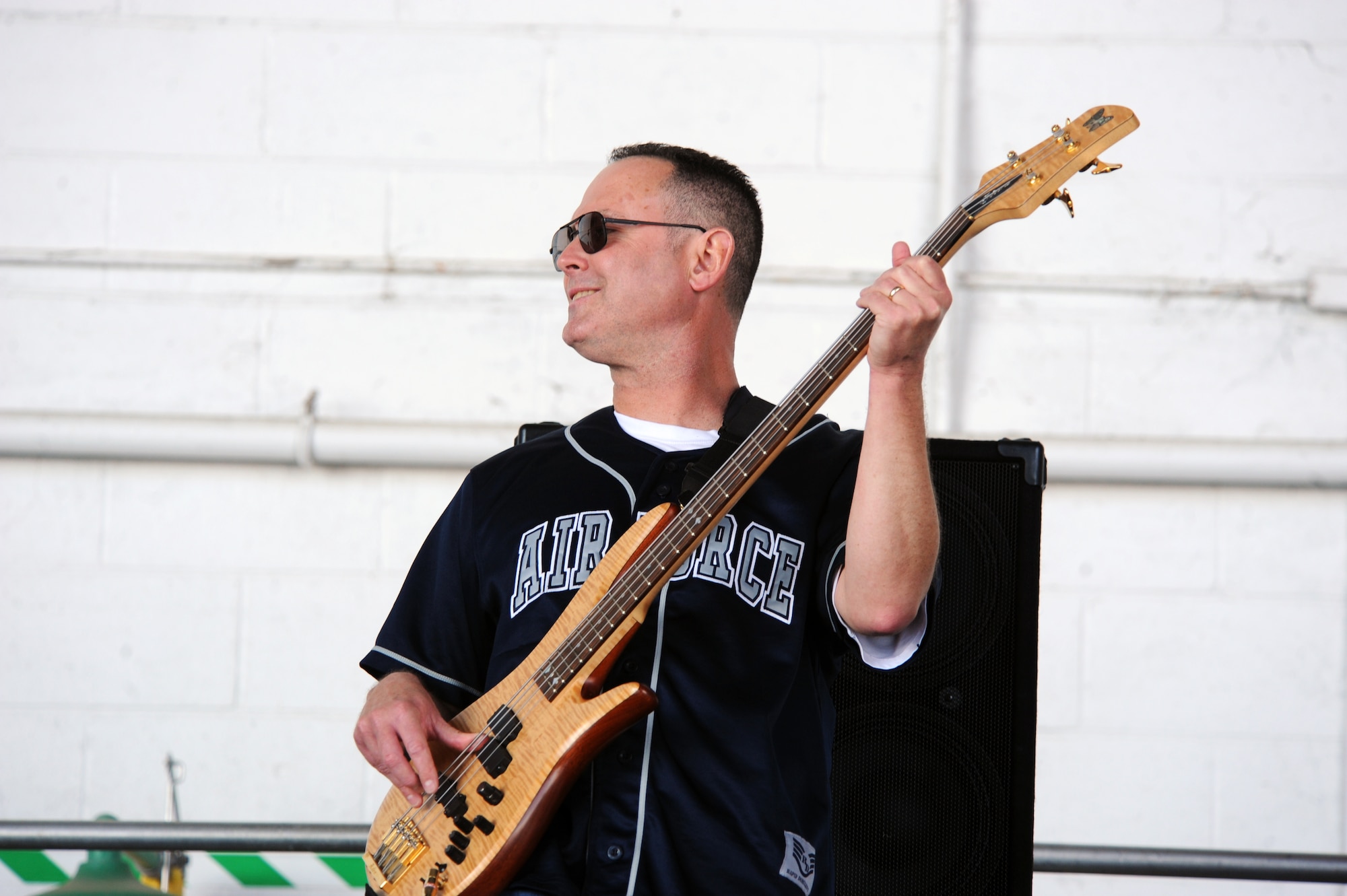 U.S. Air Force Heritage Band Blue Aces' Master Sgt. Kenneth Maurais, NCOIC Blue Aces bass guitarist, plays the song "Cheap Sunglasses" by ZZ Top during the Shaw Air Expo 2012 at Shaw Air Force Base, S.C., May 5, 2012. The attendees of the Air Expo danced and stood watching the Blue Aces playing throughout the air show. (U.S. Air Force photo by Senior Airman Tabatha McCarthy/released)