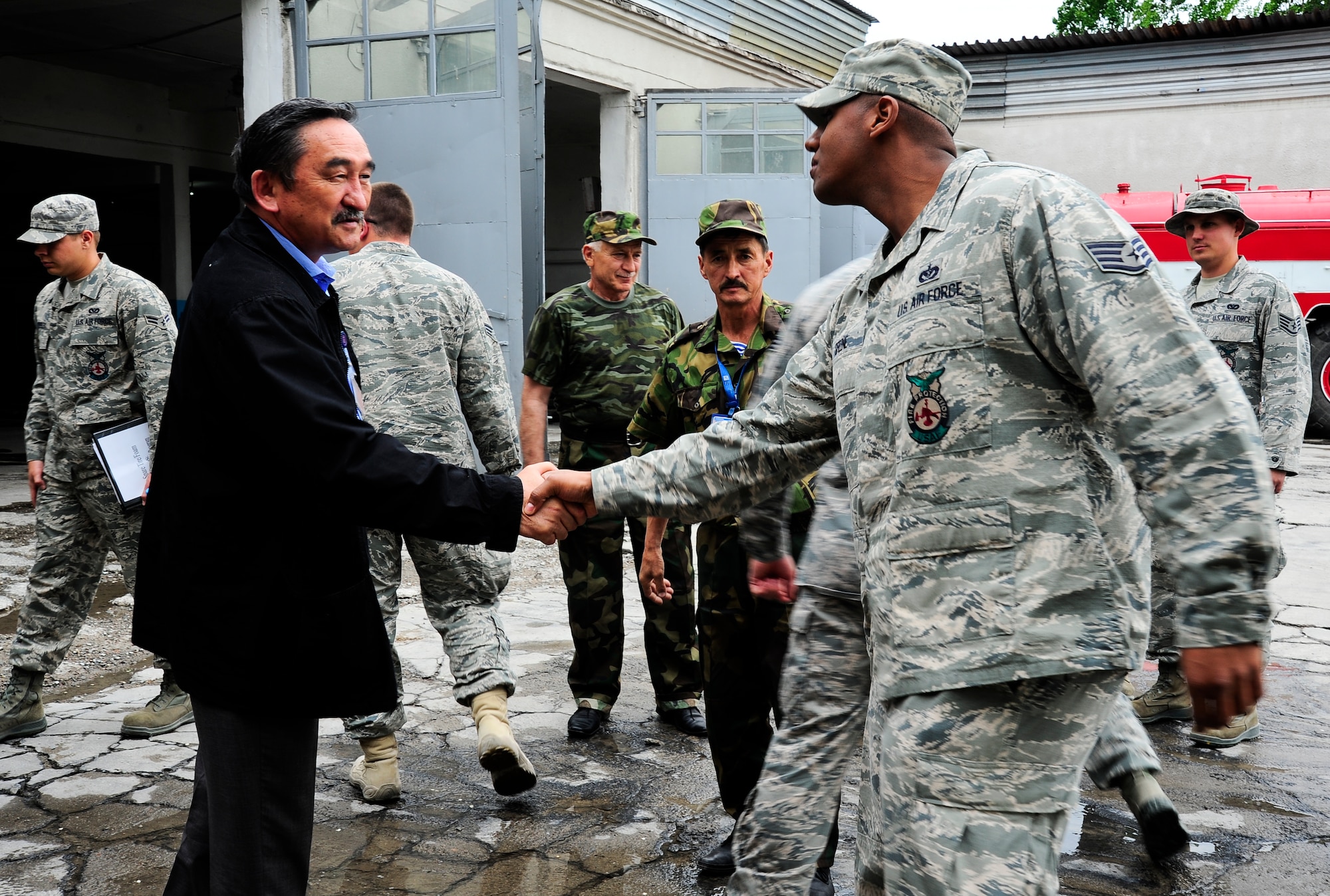 Zaynidin Seidaliev greets Staff Sgt. Tony Green April 27, 2012, at Manas International Airport fire department in Manas, Kyrgyzstan. Seidaliev is the Manas International Airport fire department chief. Greene is a 376th Civil Expeditionary Engineer Squadron fire fighter deployed here from Patrick Air Force Base, Fla. (U.S. Air Force photo/Staff Sgt. Angela Ruiz)