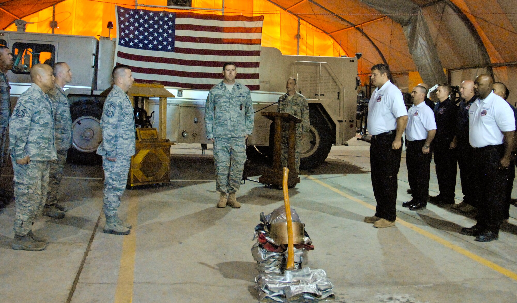 Lt. Col. Matthew Kovich, 376th Expeditionary Civil Engineer Squadron commander calls both military and civilian fire fighters to attention before releasing them from the shift change ceremony at the Transit Center at Manas fire department, Kyrgyzstan, April 30, 2012. The Sally Port Emergency Services provided fire protection at the Transit Center for the past four years. (U.S. Air Force photo/Senior Airman Lynsie Nichols)