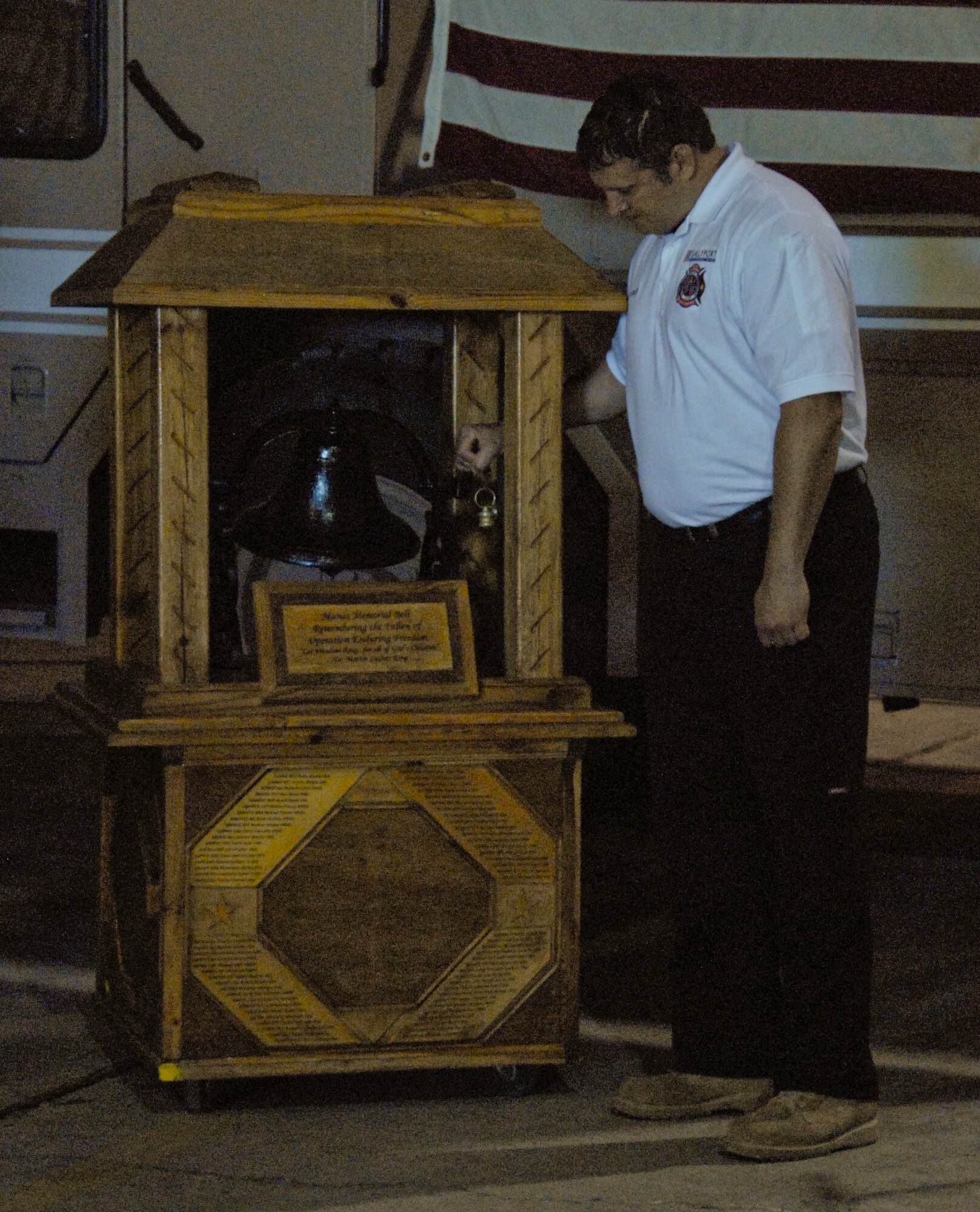George Parker III, Sally Port Fire Emergency Services fire chief, rings a bell three times April 30, 2012, at the Transit Center at Manas, Kyrgyzstan. In fire service tradition, the end of shift is signified with the sounding of the final bell. The Sally Port Emergency Services and military fire departments held a shift change ceremony to transfer authority from civilian to active-duty military fire fighters. (U.S. Air Force photo/Senior Airman Lynsie Nichols)