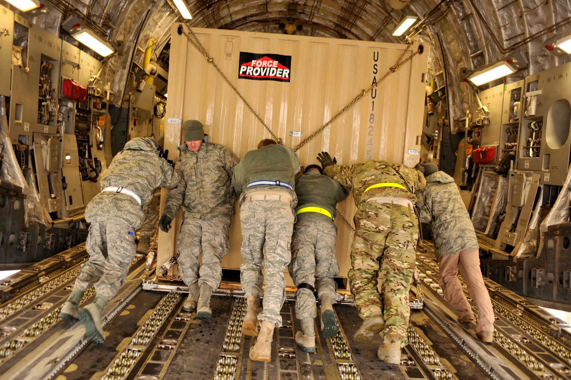 Members of the 455th Expeditionary Aerial Port Squadron load equipment onto a C-17 aircraft in support of the 1st Infantry Division’s Relief in Place/Transfer of Authority at Bagram Airfield, Afghanistan, March 20, 2012. The RIP/TOA was a joint project were the 455th Expeditionary Aerial Port Squadron, the 82nd Airborne Division, the 4th Brigade Combat Team and the 4th Infantry Division all communicating together to move the 1st Infantry Division’s equipment and personnel into place so they could easily move into their new mission. (U.S. Air Force photo/Airman 1st Class Ericka Engblom)