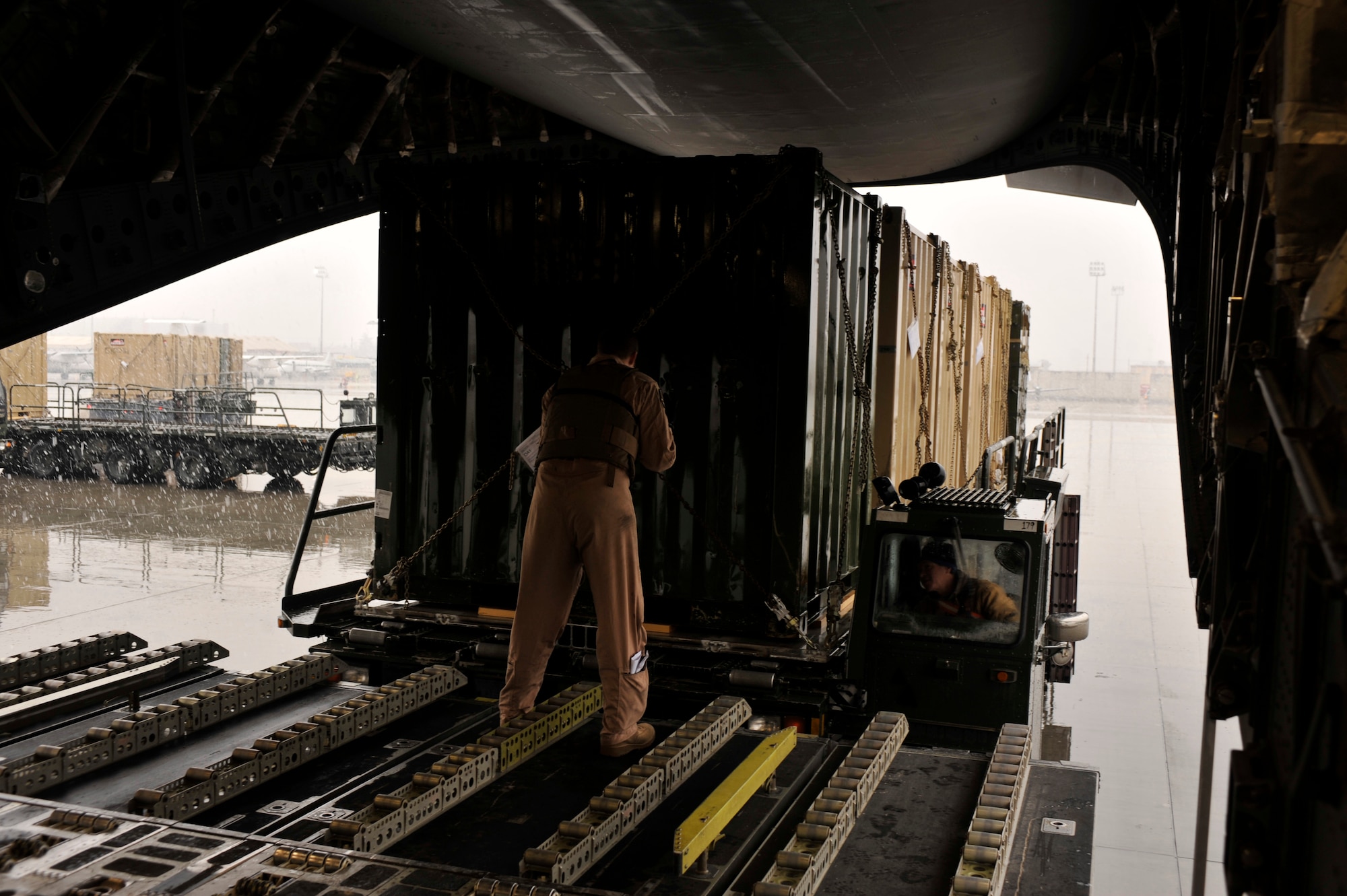 Airman 1st Class Brian Lewment supervises the loading of a C-17 aircraft in support of the 1st Infantry Division’s Relief in Place/Transfer of Authority at Bagram Airfield, Afghanistan, March 20, 2012. Lewment is a loadmaster with the 816th Air Expeditionary Squadron and is deployed from Charleston Air Force Base, S.C. The RIP/TOA relied on communication between Army and Air Force units that helped the 1st Infantry Division to transition smoothly into its new mission. (U.S. Air Force photo/Airman 1st Class Ericka Engblom)