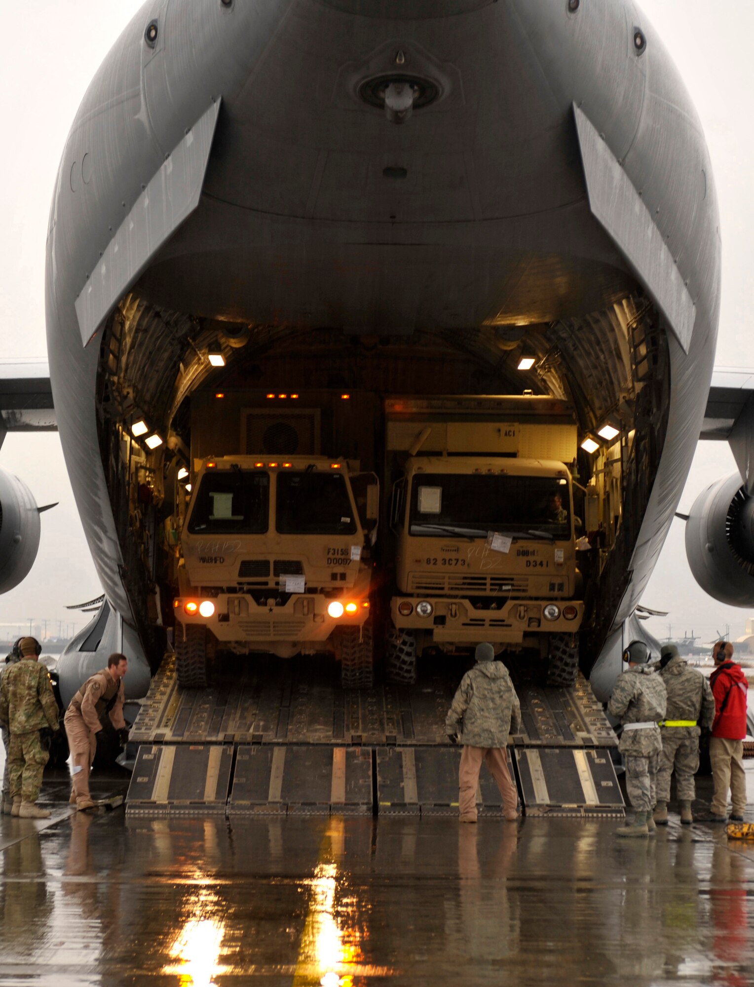 Members of the 455th Expeditionary Aerial Port Squadron prepare to unload a C-17 aircraft during a Relief in Place/Transfer of Authority at Bagram Airfield, Afghanistan, March 20, 2012. The RIP/TOA moved over 17,000 passengers and 4,000 tons of cargo and allowed 1st Infantry Division to settle into their new mission of handling the dealings the Afghan government and Afghan National Security Forces. (U.S. Air Force photo/Airman 1st Class Ericka Engblom)