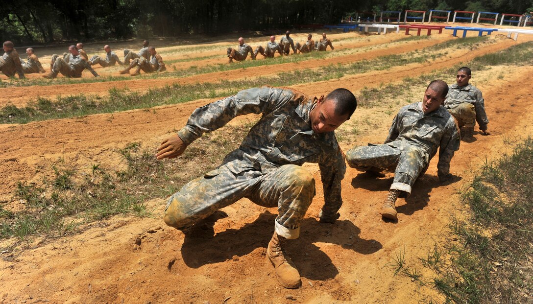 Soldiers in basic training run through an obstacle course as Defense Secretary Leon E. Panetta visits troops on Fort Benning, Ga., May 4, 2012. 