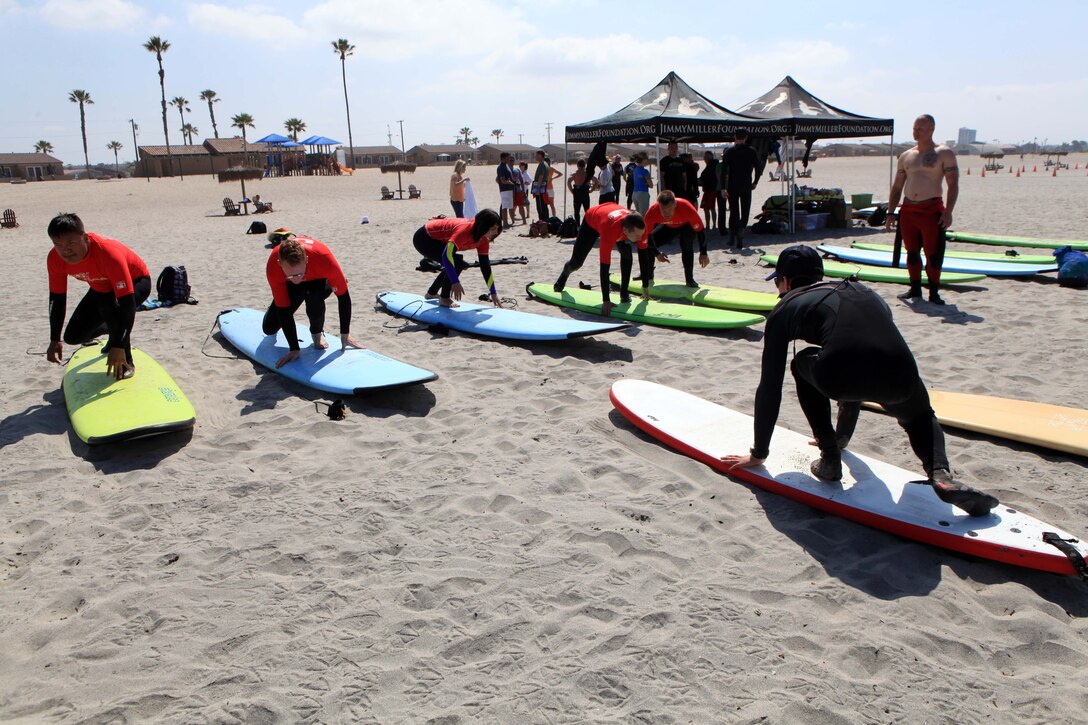 A Jimmy Miller Memorial Foundation volunteer instructor gives a tutorial of proper surfing technique to service members with the Wounded Warrior Battalion in Del Mar, May 5. The JMMF ocean therapy program facilitates improved self-esteem for service members dealing with mental and physical illness.