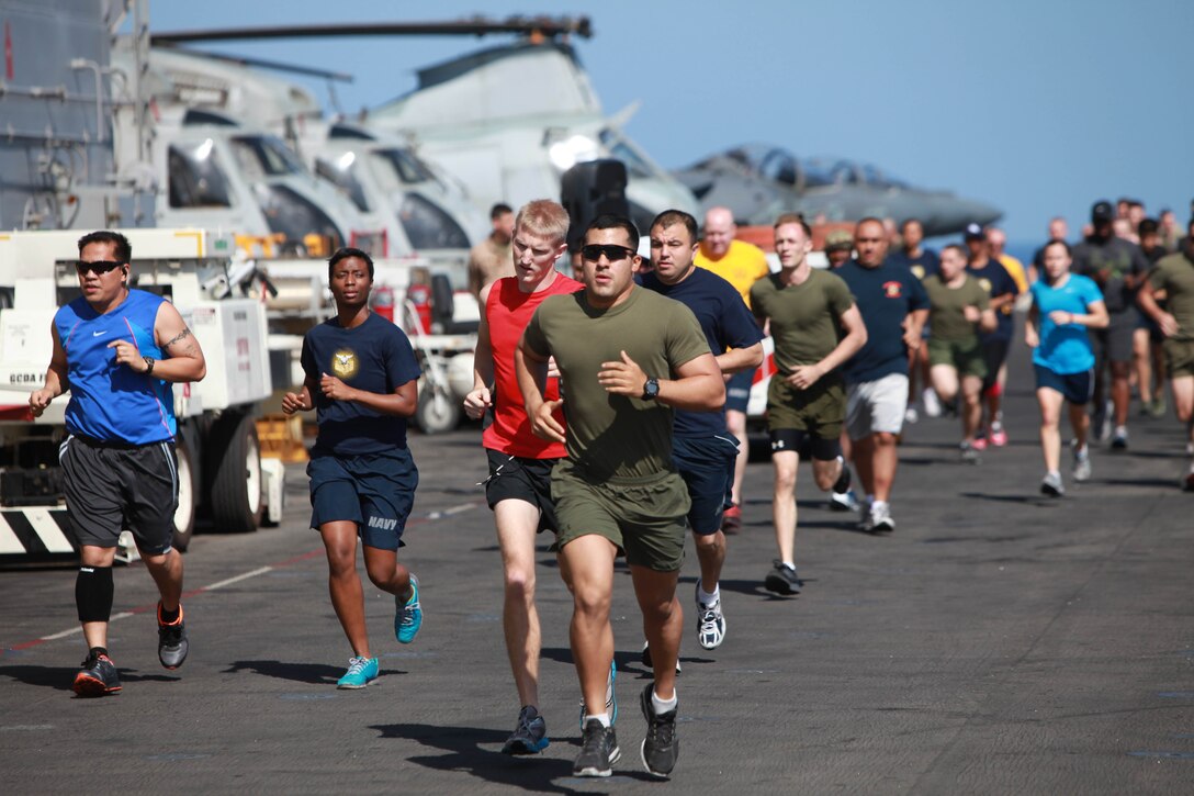 Marines with the 11th Marine Expeditionary Unit and sailors aboard USS Makin Island run here May 5. The unit is deployed as part of the Makin Island Amphibious Ready Group, currently a U.S. Central Command theater reserve force. The group is providing support for maritime security operations and theater security cooperation efforts in the U.S. Navy's 5th Fleet area of responsibility.