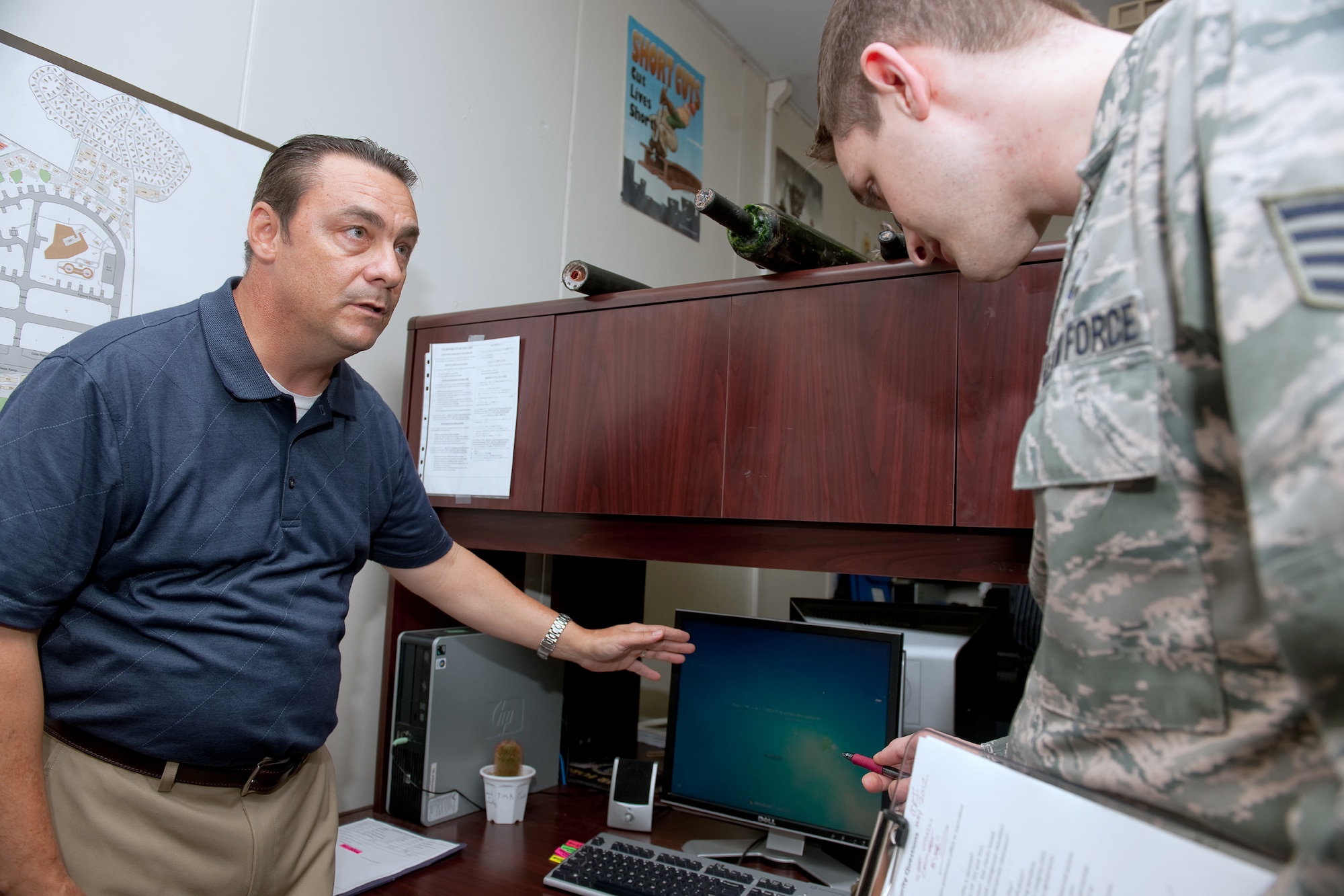 YOKOTA AIR BASE, Japan -- Glenn Kepper, left, Command Cyber Readiness Inspection Team traditional reviewer, and Staff Sgt. Thomas Vitulli, 374th Communications Squadron wing information assurance manager, inspect physical security, communications security and information security of an Airman's desk during CCRI at Yokota Air Base, Japan, May, 3, 2012. The Defense Information Systems Agency conducted the 374th Airlift Wing's CCRI from April 30 to May 4. Team Yokota has earned the best combined CCRI score in the Air Force to date for fiscal 2012. (U.S. Air Force photo by Osakabe Yasuo)