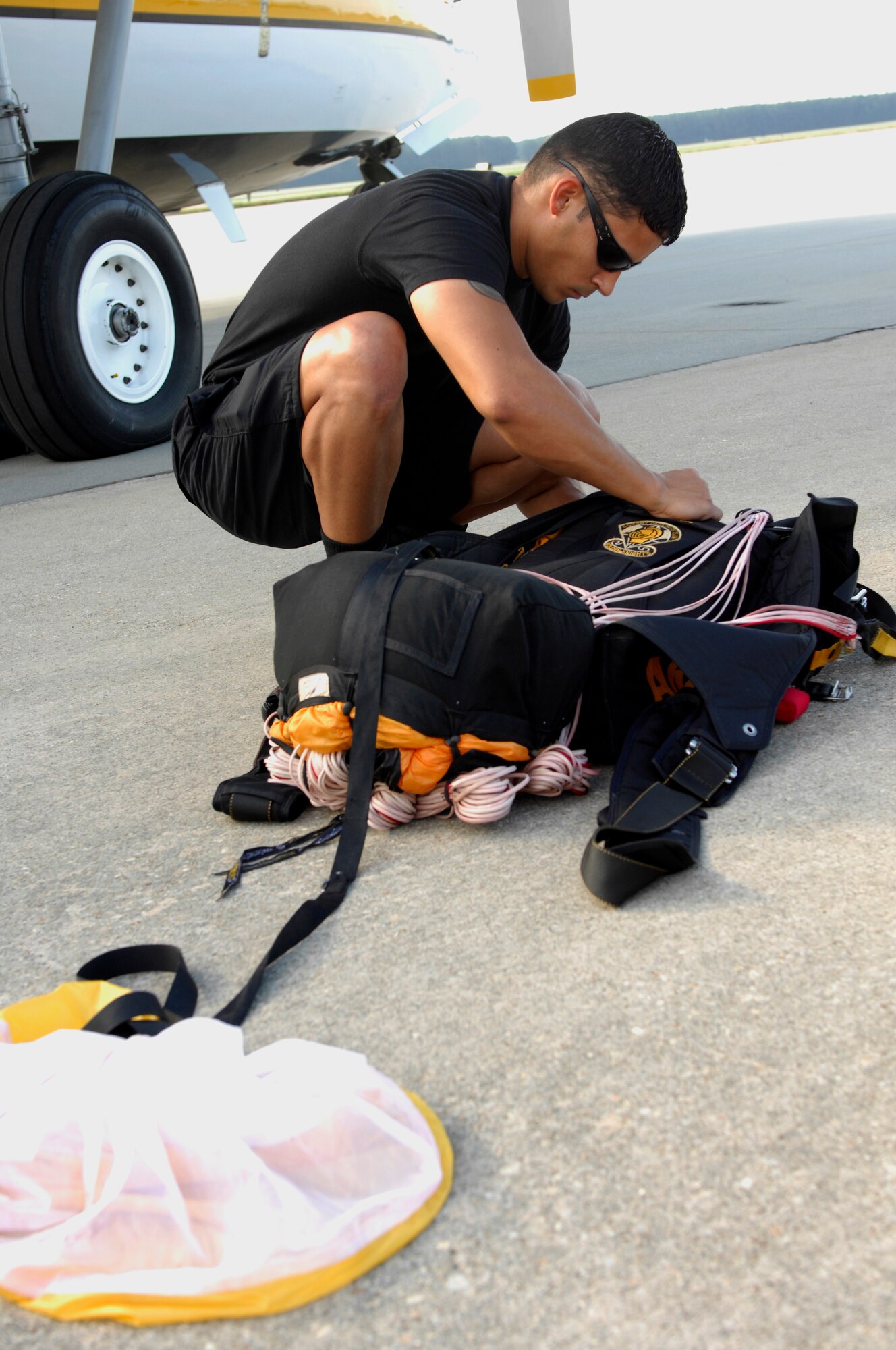 U.S. Army  Sgt. John Lopez, U.S. Army Golden Knights Parachute Team, prepares his parachute before performing at 2012 Shaw Air Expo  at Shaw Air Force Base, S.C. on May 6, 2012. Team members examine each parachute carefully before jumping as one of their safety procedures. Lopez and his teammates jumped from heights between 2,000 to 15,000 feet during the air show. The expo concluded on May 6. (U.S. Air Force photo by Airman 1st Class Krystal M. Jeffers/Released)