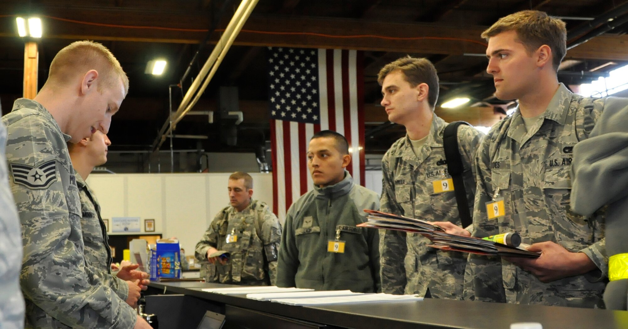 Team McChord Airmen, both active duty and Reserve, listen to a finance briefing as part of their deployment line checklist for a fly-away operational readiness exercise May 6. More than 300 Airmen from various squadrons travelled on C-17 Globemasters to an undisclosed deployed location where they will simulate 24-hour operations in a combat zone. This exercise is in preparation for the operational readiness inspection set for October. (U.S. Air Force photo/Staff Sgt. Rachael Garneau)