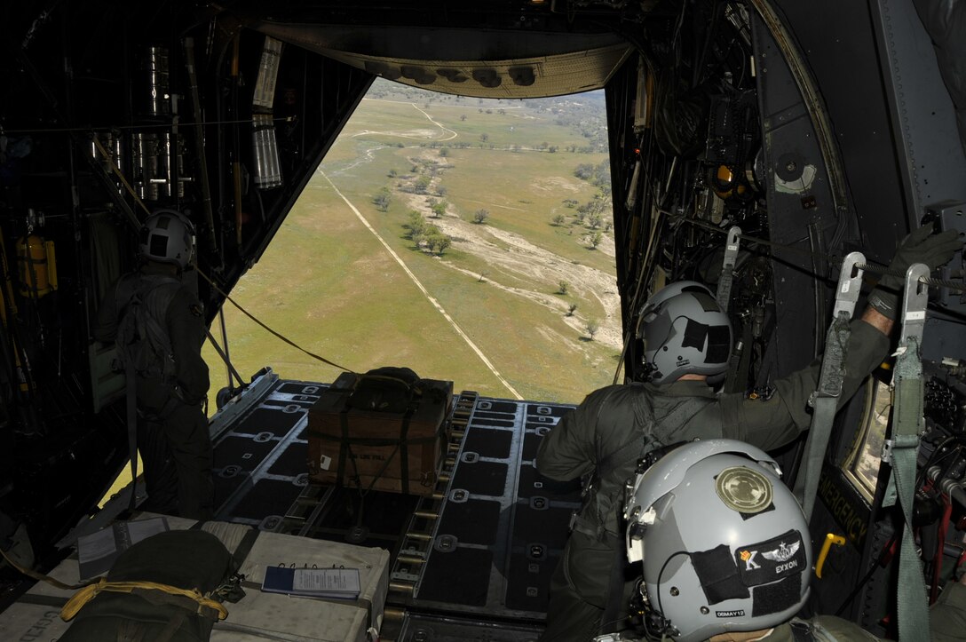 Members of the 130th Rescue Squadron conduct container ramp load (CRL) training in a MC-130P Combat Shadow over Fort Hunter Liggett, Calif., April 15, 2012. The CRL training simulates equipment drops and is conducted every six months. (Air National Guard photo by Staff Sgt. Kim E. Ramirez)