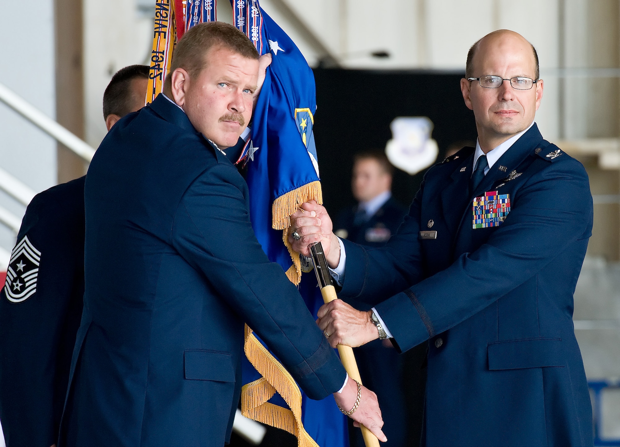 Col. Raymond A. Kozak (right) assumes command of the 512th Airlift Wing from 4th Air Force Commander Maj. Gen. Mark A. Kyle during a ceremony May 6, 2012, on Dover Air Force Base, Del.  Col. Randal L. Bright, who served as the 512th AW commander for the past five years, is reassigned to Robins AFB, Ga. (U.S. Air Force photo by Roland Balik)