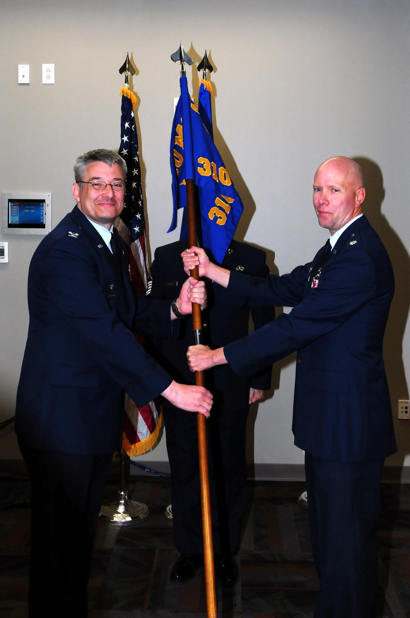 Maj. Cynthia Marcello assumed command of the 310th Force Support Squadron from the outgoing commander, Lt. Col. Kevin Graefe, at a change-of-command ceremony on April 15 at the newly completed Air Reserve Personnel Center at Buckley Air Force Base, Colo. (U.S. Air Force Photo/Staff Sgt. Jeffrey Fitzmorris)