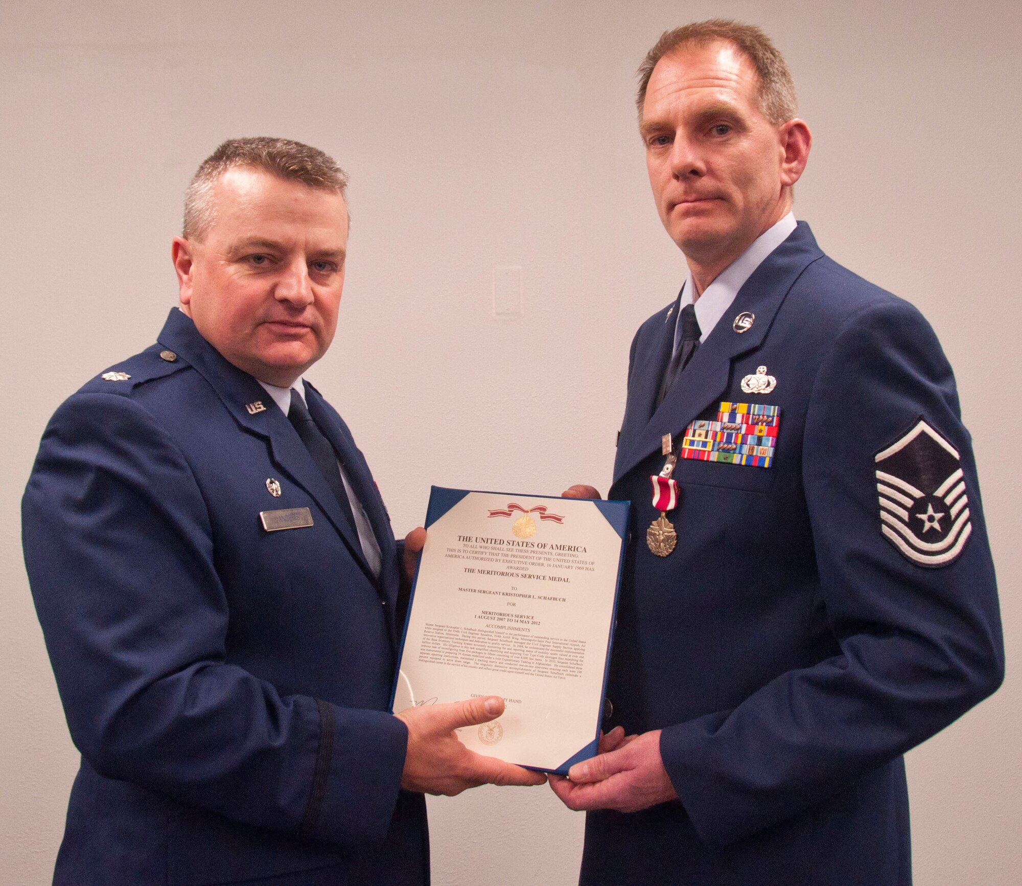 Lt. Col. Bryan G. Anders, commander of the 934th Civil Engineering Squadron presents Master Sgt. Kristopher L. Schaufbuch with the Meritorious Service Medal during the Sergeant's retirement ceremony from 934th CES, May 5, 2012. (U.S. Air Force Photo/Tech. Sgt. Jim Loehr)