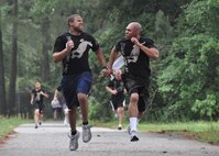 Members of the 916th Air Refueling Wing Training Flight push each other to the finish line during the wing's semi-annual Warrior Run held on Sunday, May 6, 2012. (USAF photo by Master Sgt. Wendy Lopedote, 916ARW, released)