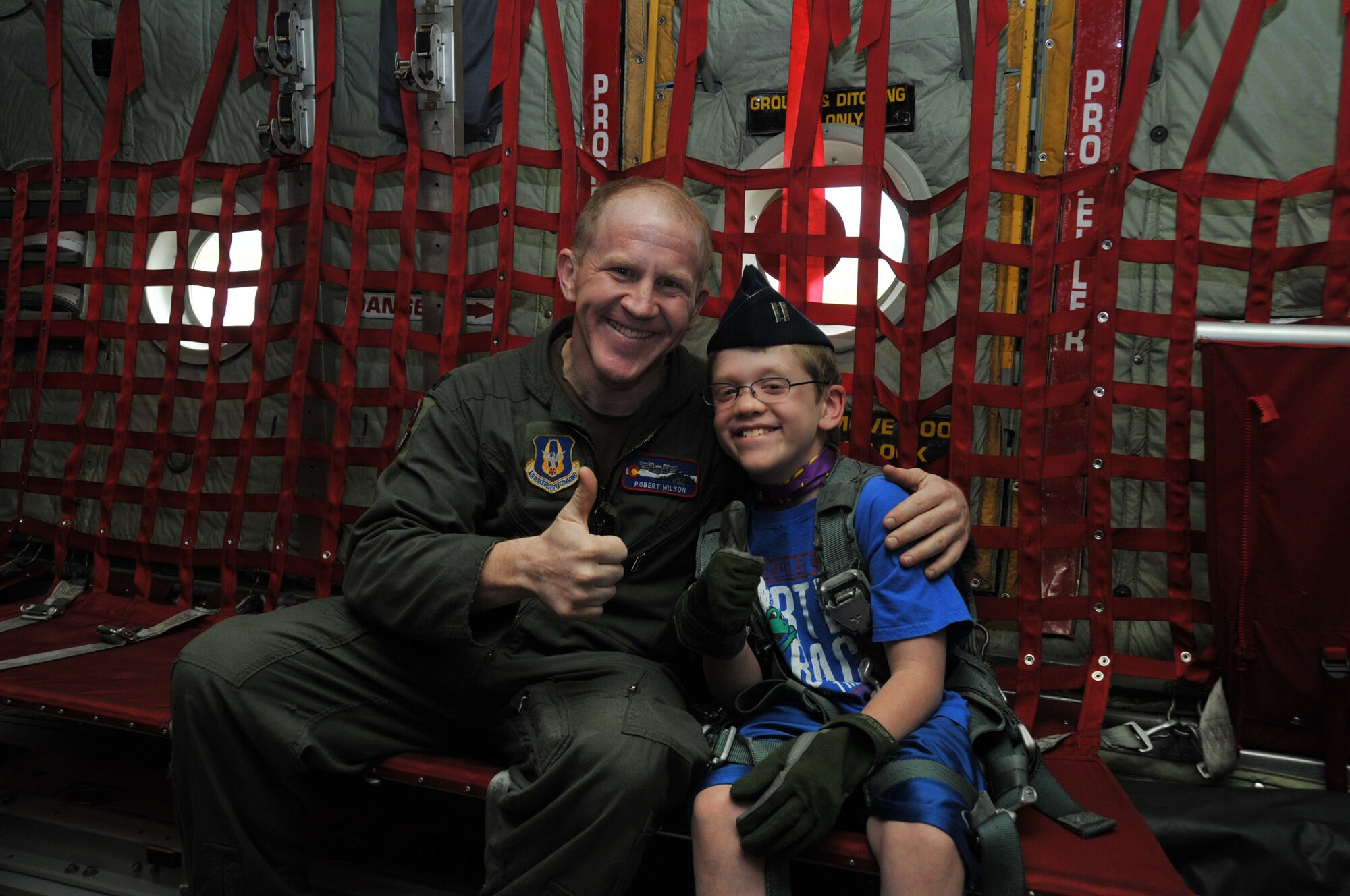 A.J. Neppl of Apple Valley, Minn., gets a tour of a C-130 from Air Force Reserve Captain Robert Wilson, a pilot with the 302nd Airlift Wing, Peterson Air Force Base, Colo.  The two met for the first time at Minneapolis-St. Paul Air Reserve Station, almost 3 years after Capt. Wilson donated lifesaving bone marrow to the then 7 year old boy.  (U.S. Air Force Photo/Tech. Sgt. Bob Sommer)